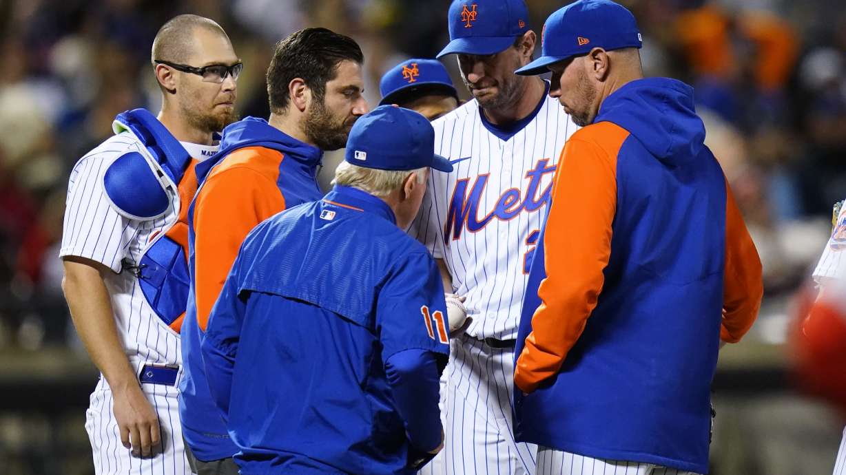 New York Mets starting pitcher Max Scherzer hands the ball to manager Buck Showalter during the sixth inning of the team's baseball game against the St. Louis Cardinals on Wednesday, May 18, 2022, in New York.