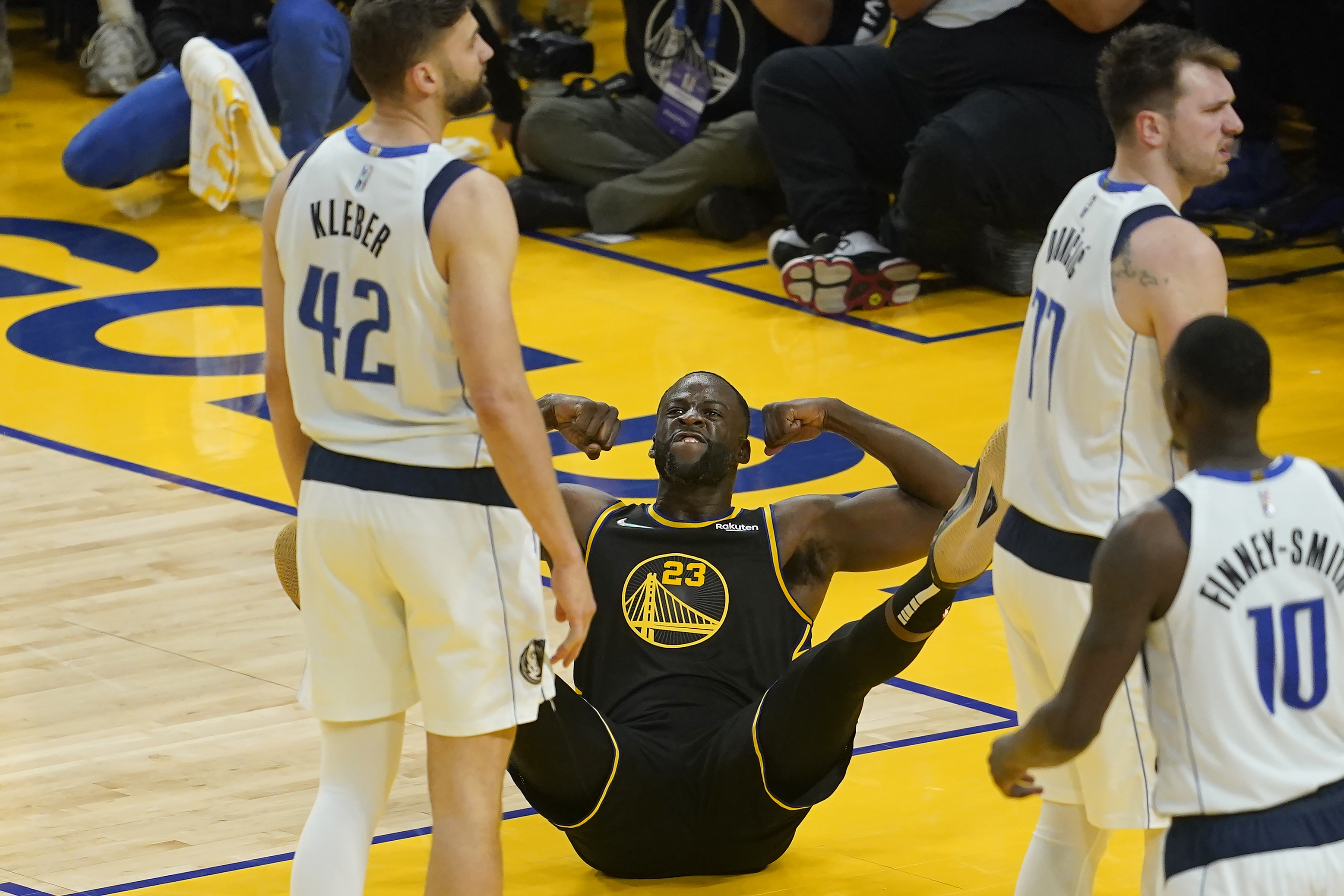 Golden State Warriors forward Draymond Green (23) reacts after scoring and being fouled behind Dallas Mavericks forward Maxi Kleber (42) and guard Luka Doncic, right, during the first half of Game 1 of the NBA basketball playoffs Western Conference finals in San Francisco, Wednesday, May 18, 2022. 