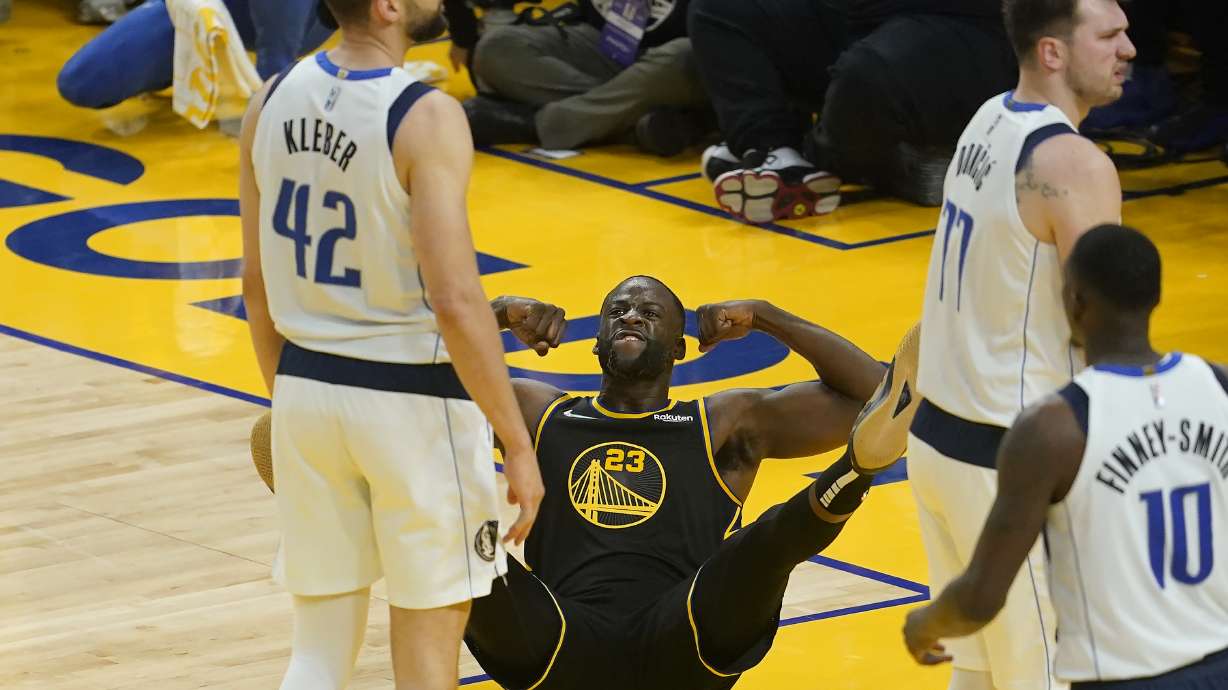 Golden State Warriors forward Draymond Green (23) reacts after scoring and being fouled behind Dallas Mavericks forward Maxi Kleber (42) and guard Luka Doncic, right, during the first half of Game 1 of the NBA basketball playoffs Western Conference finals in San Francisco, Wednesday, May 18, 2022.