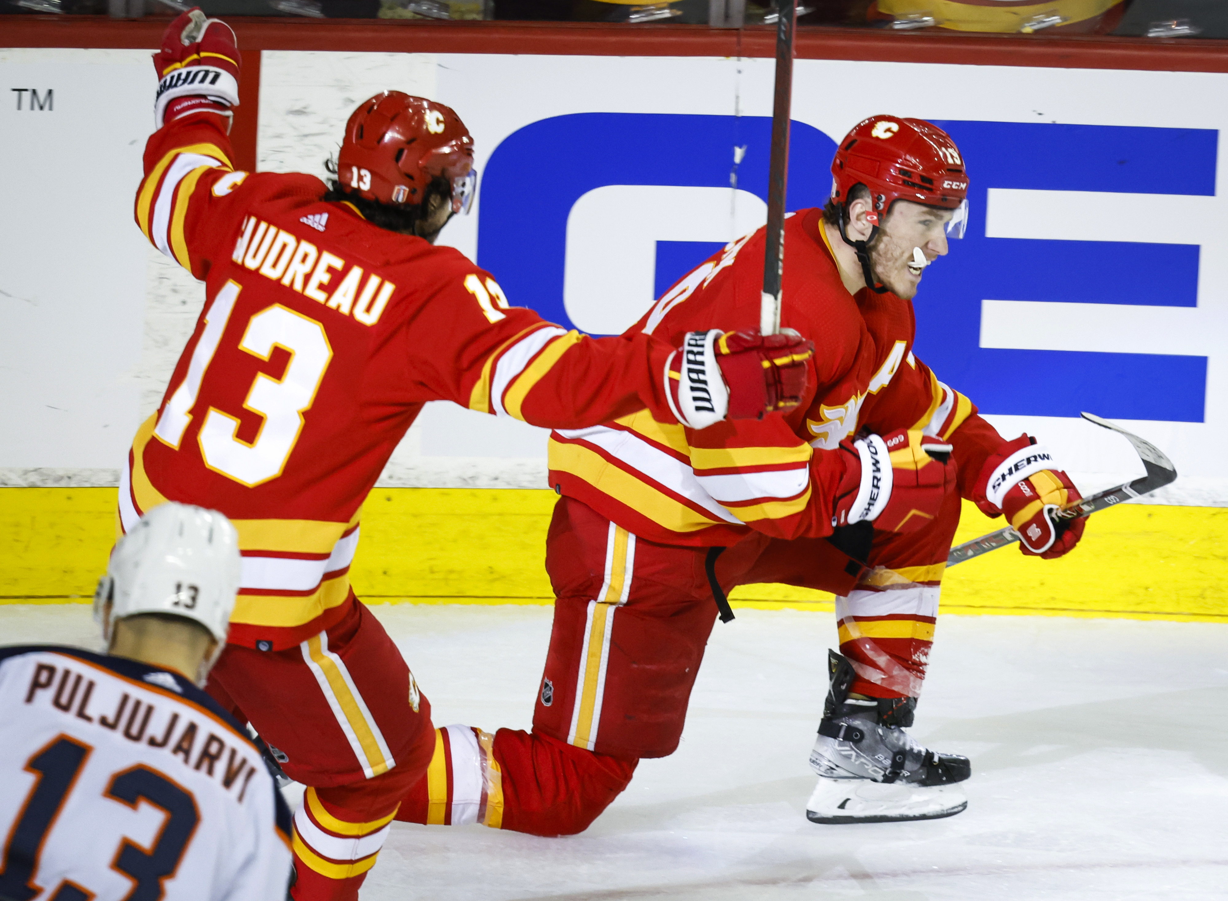 Calgary Flames forward Matthew Tkachuk, right, celebrates his goal against the Edmonton Oilers with forward Johnny Gaudreau during the third period of Game 1 of an NHL hockey second-round playoff series Wednesday, May 18, 2022, in Calgary, Alberta. 