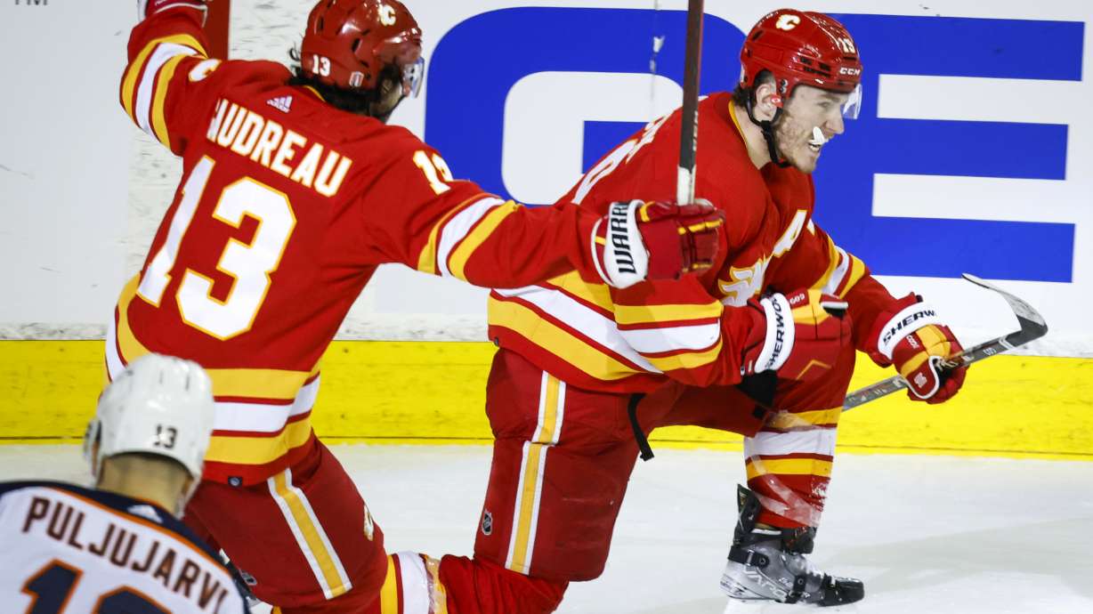 Calgary Flames forward Matthew Tkachuk, right, celebrates his goal against the Edmonton Oilers with forward Johnny Gaudreau during the third period of Game 1 of an NHL hockey second-round playoff series Wednesday, May 18, 2022, in Calgary, Alberta.