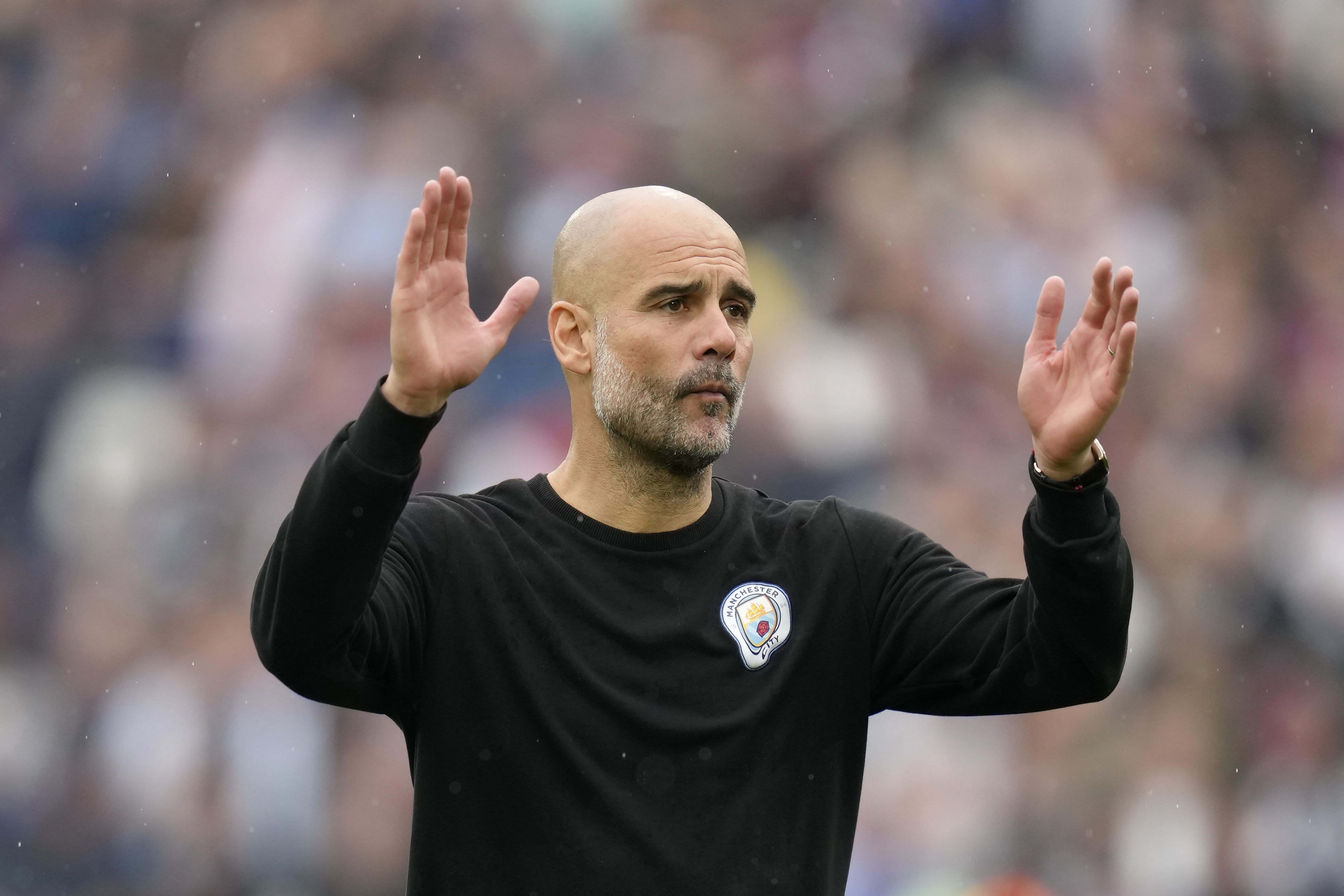 Manchester City's head coach Pep Guardiola reacts at the end of the English Premier League soccer match between West Ham United and Manchester City at London stadium in London, Sunday, May 15, 2022. 