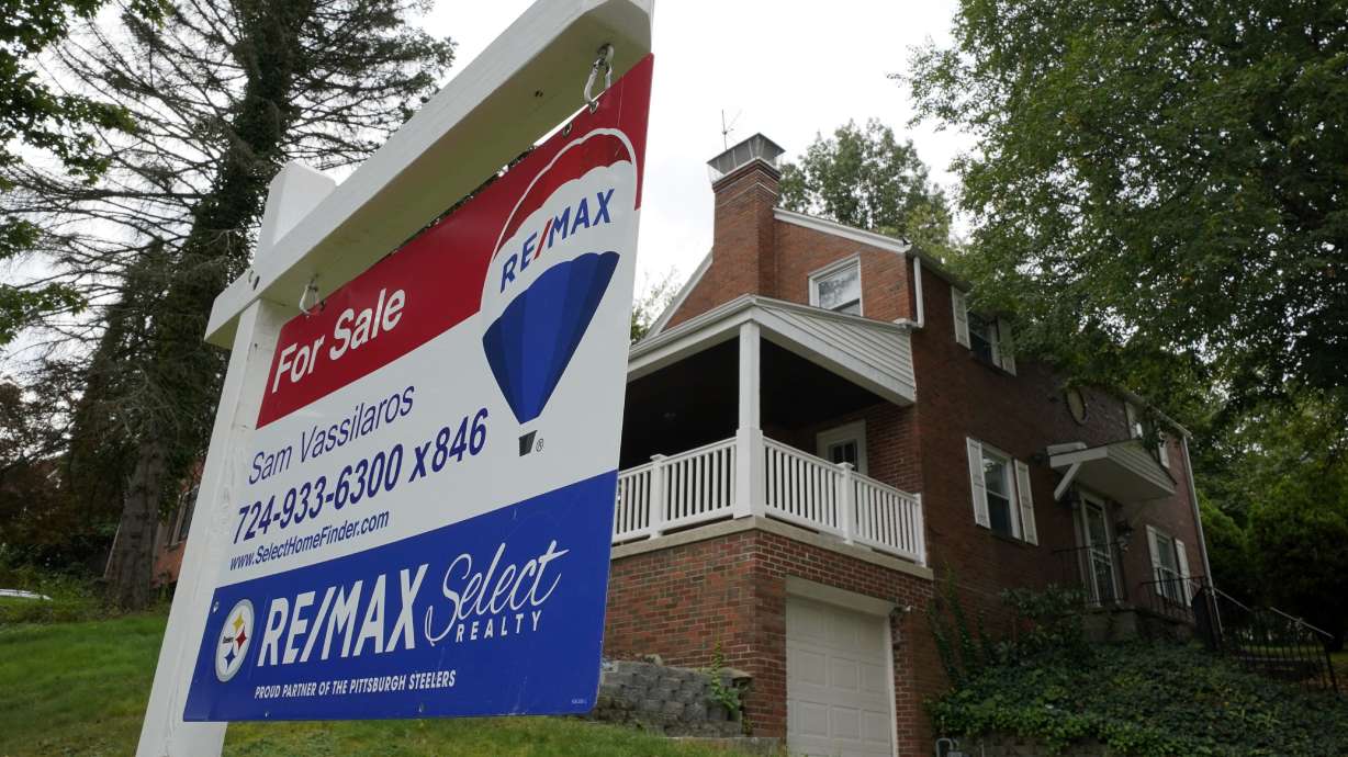 A for sale sign is displayed outside a home in Mount Lebanon, Pa., on Sept. 21, 2021. Sales of previously occupied U.S. homes slowed in April for the third month in a row as mortgage rates surged, driving up borrowing costs for would-be homebuyers as home prices soared to new highs.