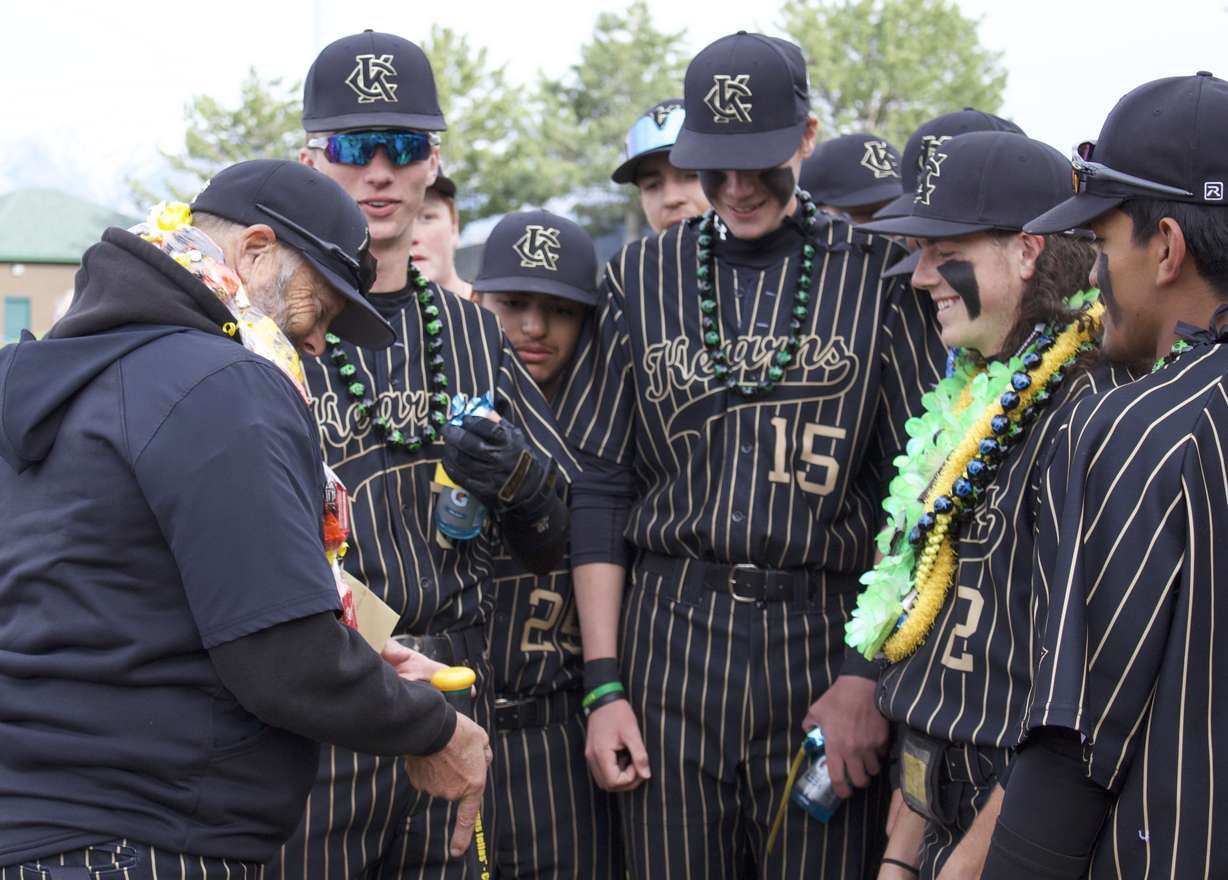 Kearns baseball gifts a wood bat to outgoing coach Dave Ballard, who is retiring after 30 years in coaching, during Ballard's final home game at Gates Field.