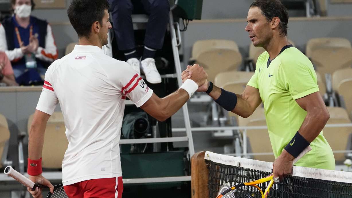 FILE - Serbia's Novak Djokovic, left, shakes hands with Spain's Rafael Nadal after their semifinal match of the French Open tennis tournament at the Roland Garros stadium, Friday, June 11, 2021 in Paris. Novak Djokovic won 3-6, 6-3, 7-6 (4), 6-2. The draw for this year’s tournament at Roland Garros was held in Paris on Thursday.