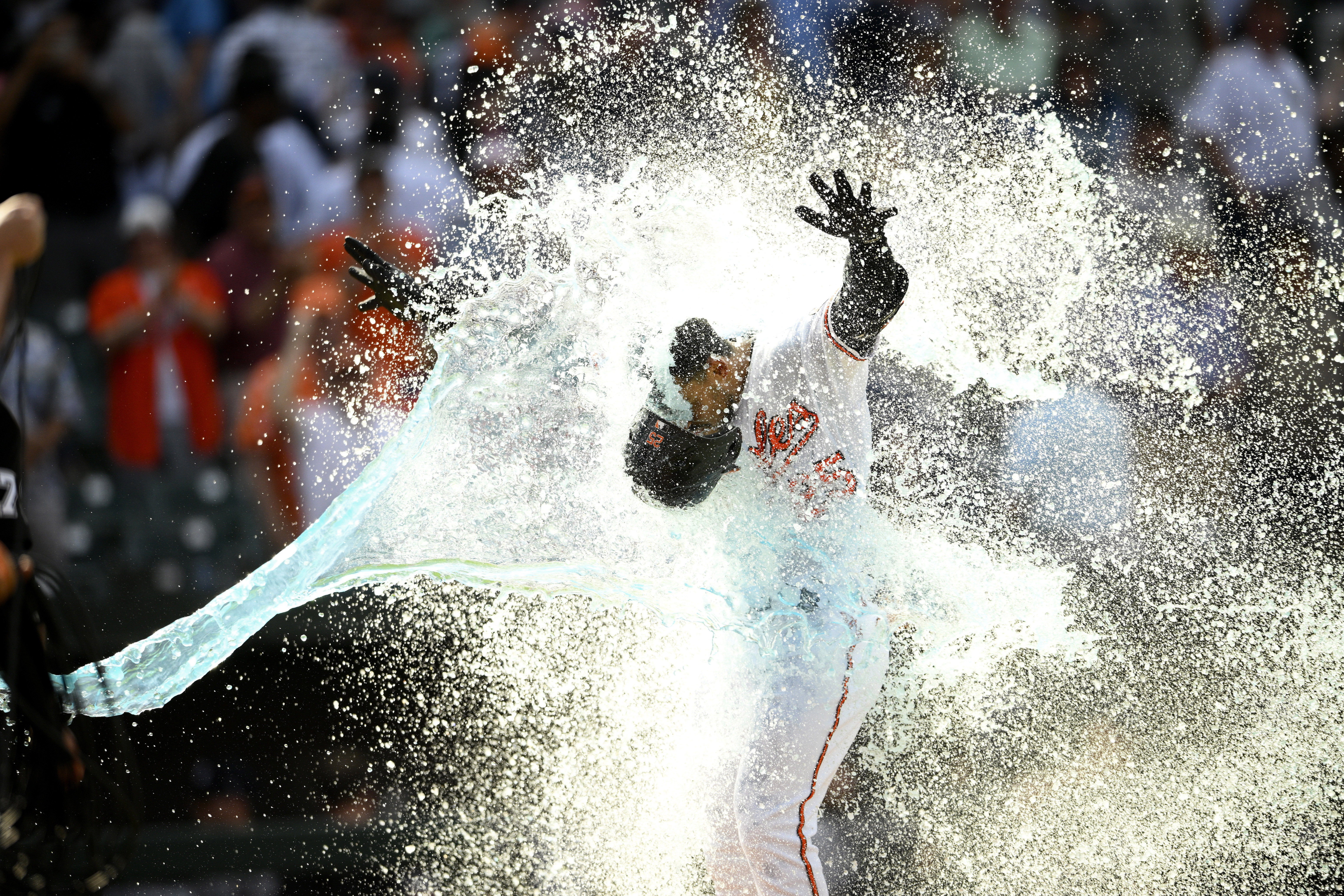 Baltimore Orioles' Anthony Santander is doused as he celebrates heading home after hitting a three-run walk off home run during the ninth inning of a baseball game against the New York Yankees, Thursday, May 19, 2022, in Baltimore. The Orioles won 9-6. 