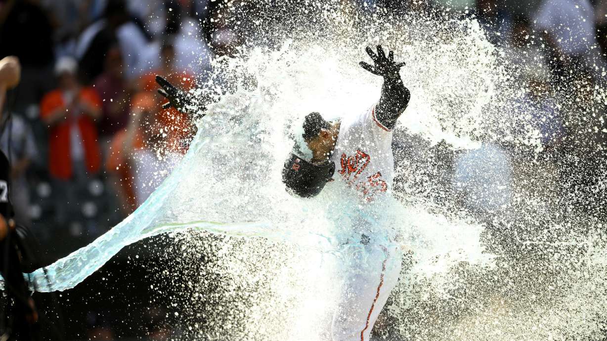 Baltimore Orioles' Anthony Santander is doused as he celebrates heading home after hitting a three-run walk off home run during the ninth inning of a baseball game against the New York Yankees, Thursday, May 19, 2022, in Baltimore. The Orioles won 9-6.