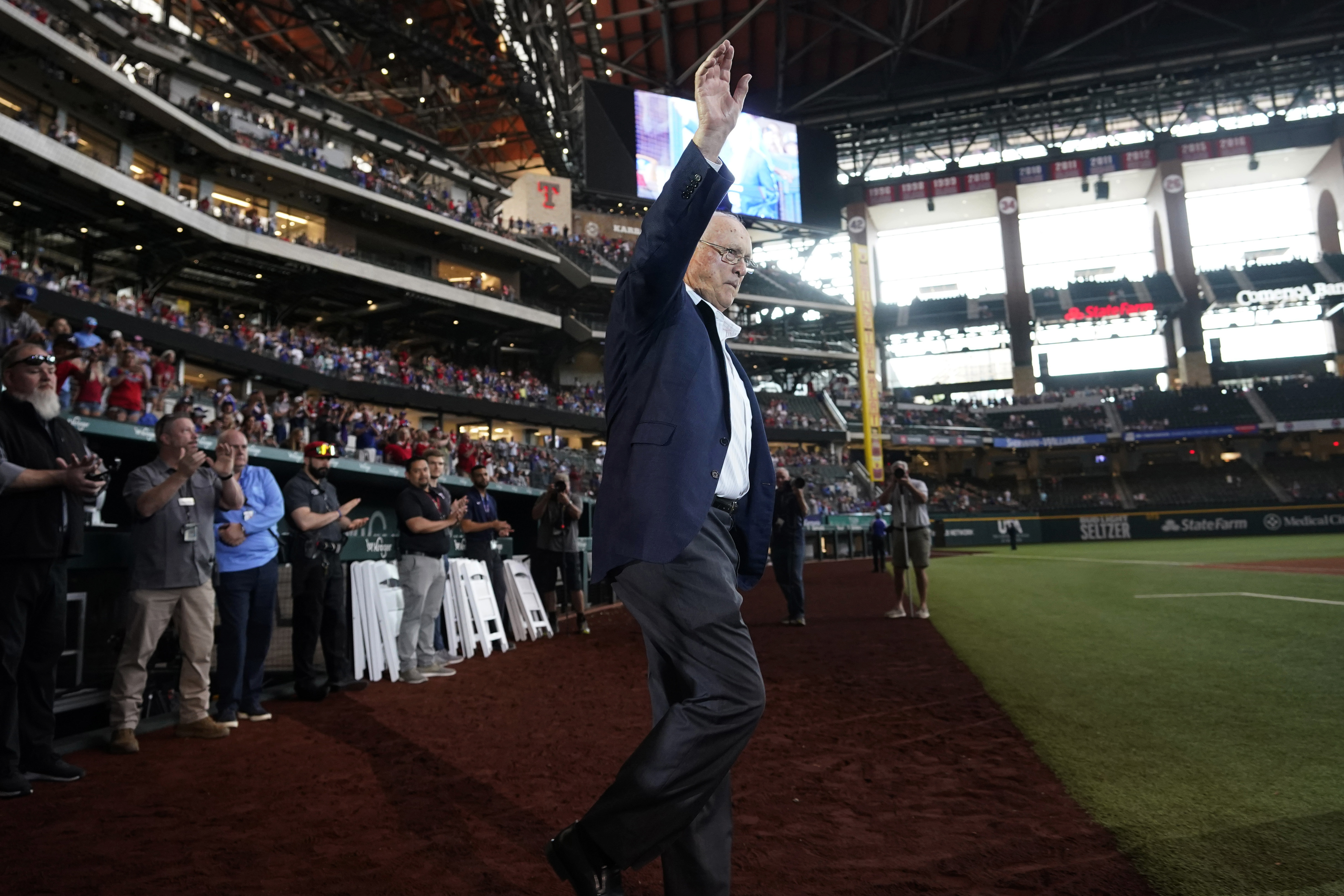 FILE - Baseball great and former Texas Rangers pitcher Nolan Ryan waves to the crowd as he takes the field for a screening of a documentary film about him, after a baseball ball game between the Atlanta Braves and Texas Rangers in Arlington, Texas, Sunday, May 1, 2022.