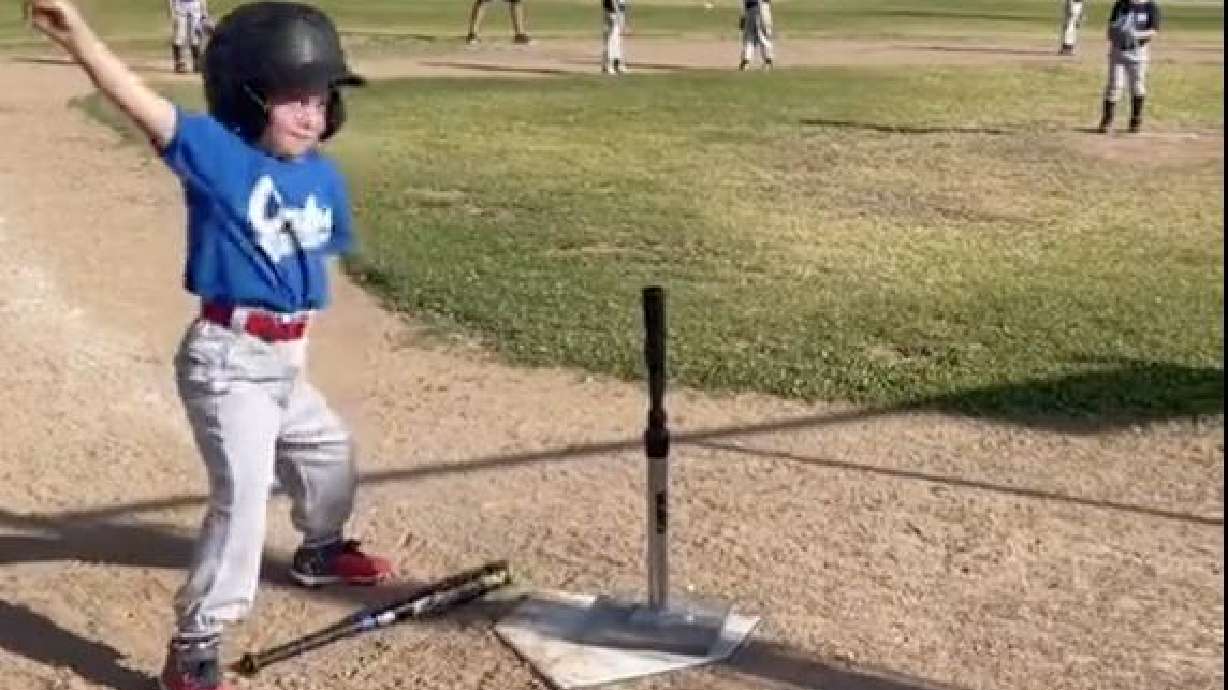 A little tee-baller busts a move before belting a single.