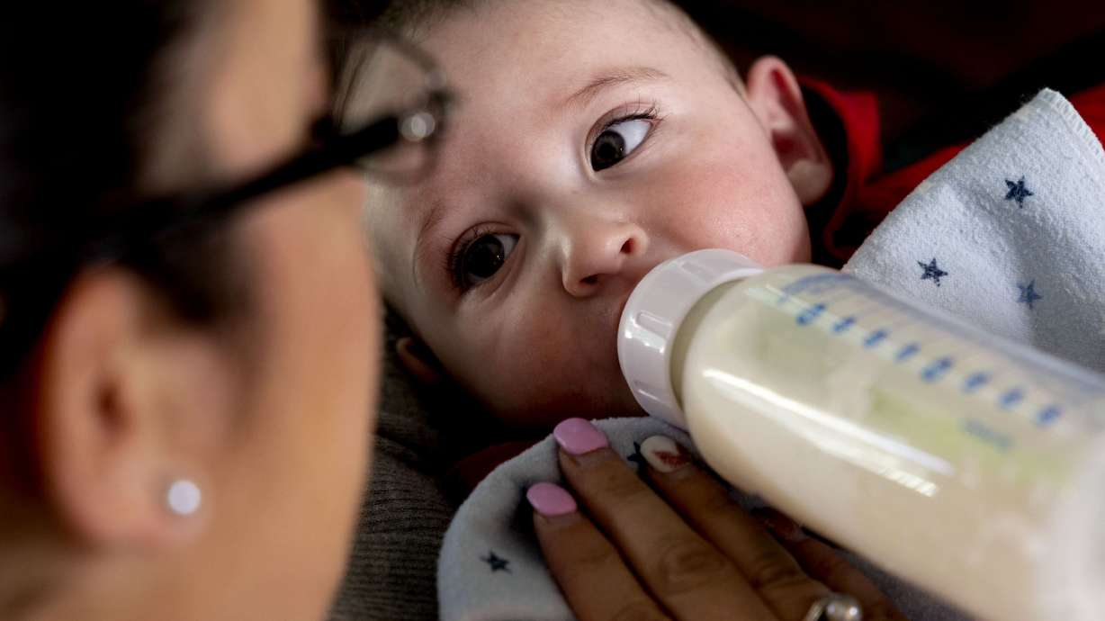 Cyndle Bass feeds 5-month-old Austin formula at their Eagle Mountain home on May 11. All four of Utah's Republican congressmen voted against providing $28 million to the Food and Drug Administration to address the issue.