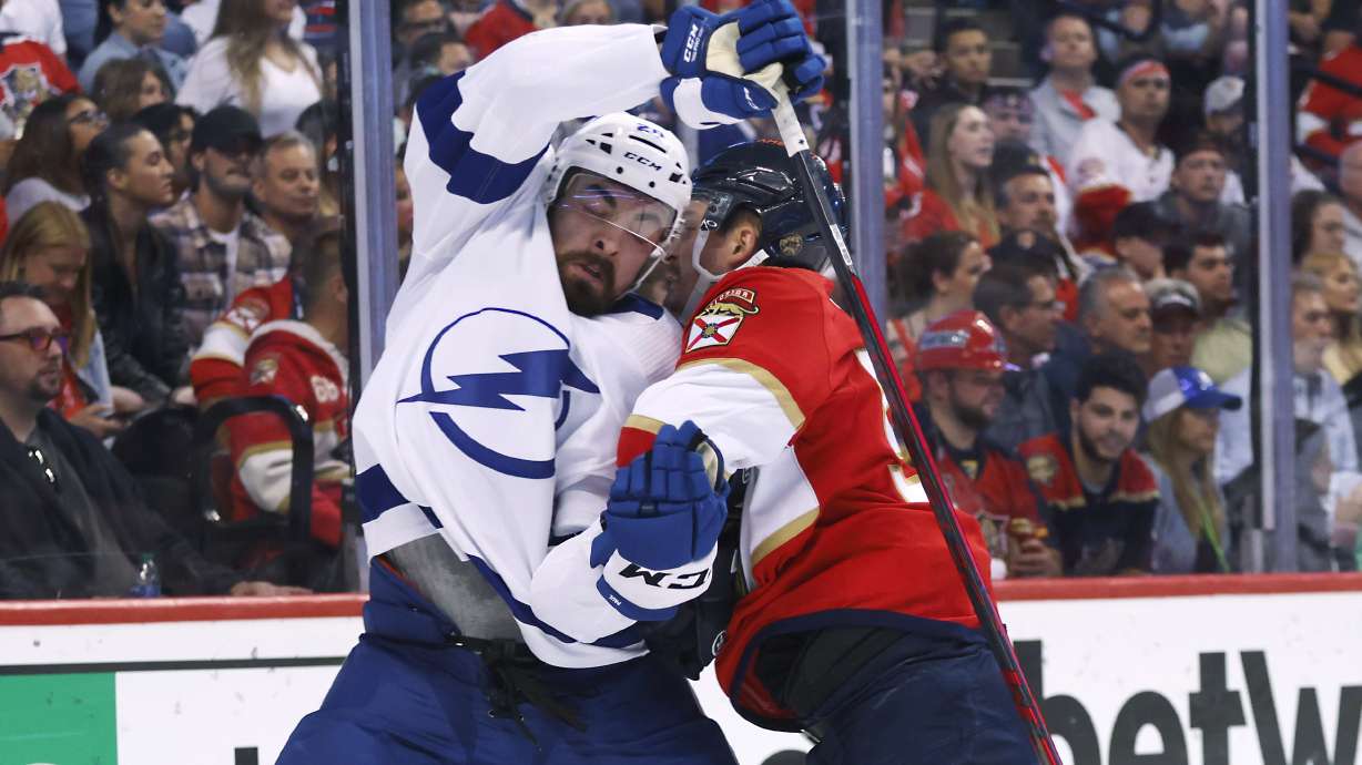 Florida Panthers center Noel Acciari, right, knocks Tampa Bay Lightning left wing Nicholas Paul (20) off the puck during the first period of Game 2 of an NHL hockey second-round playoff series Thursday, May 19, 2022, in Sunrise, Fla.