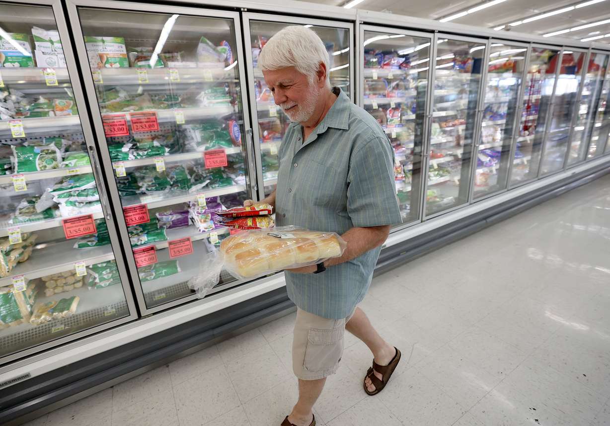 Tom Faircloth shops at a Reams in Sandy, Utah, on Wednesday. Faircloth says he has cut back on the amount of meat he purchases due to inflation.