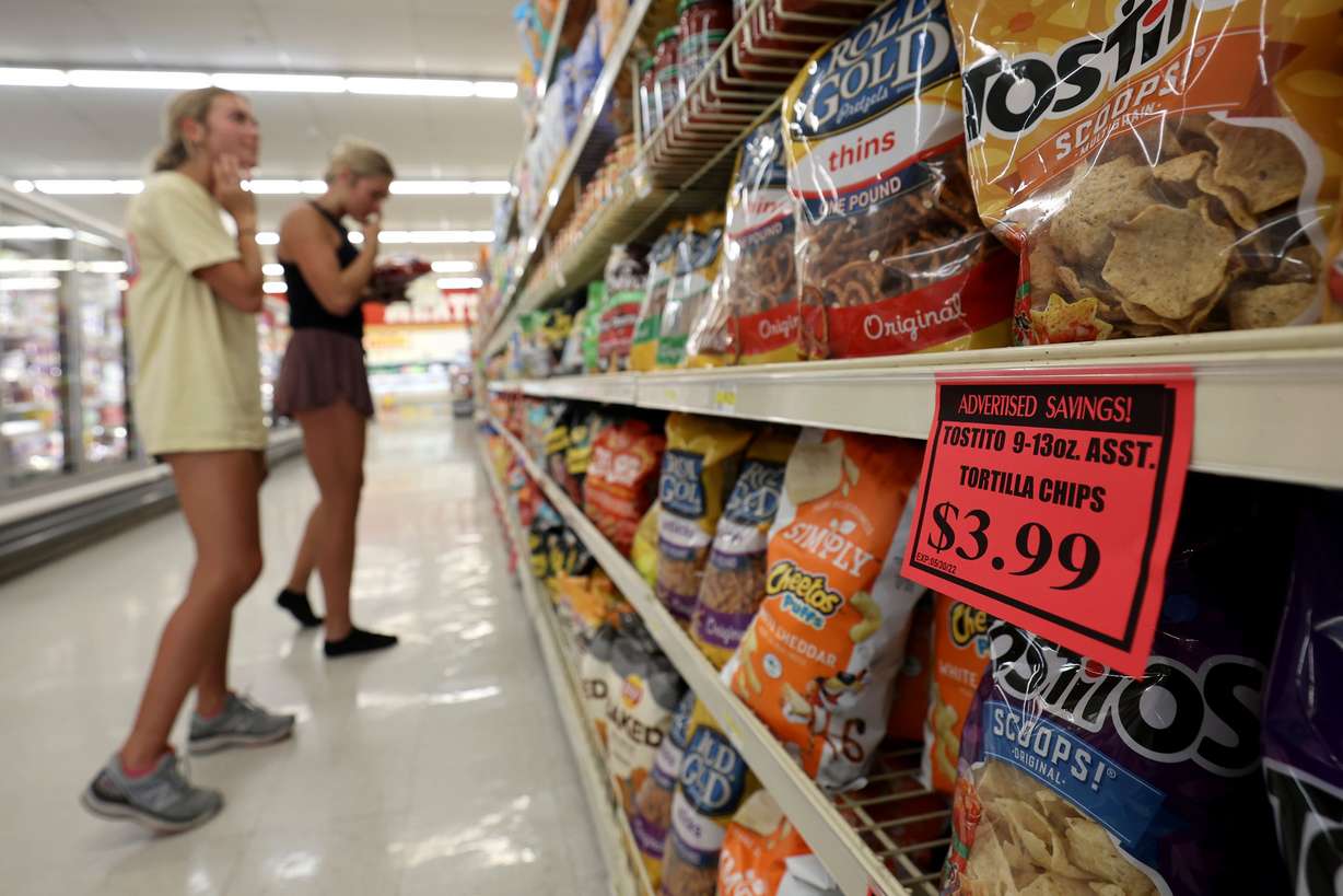 Elle Johnsen and Maddy La Fleur shop for chips at a Reams in Sandy, Utah, on Wednesday.