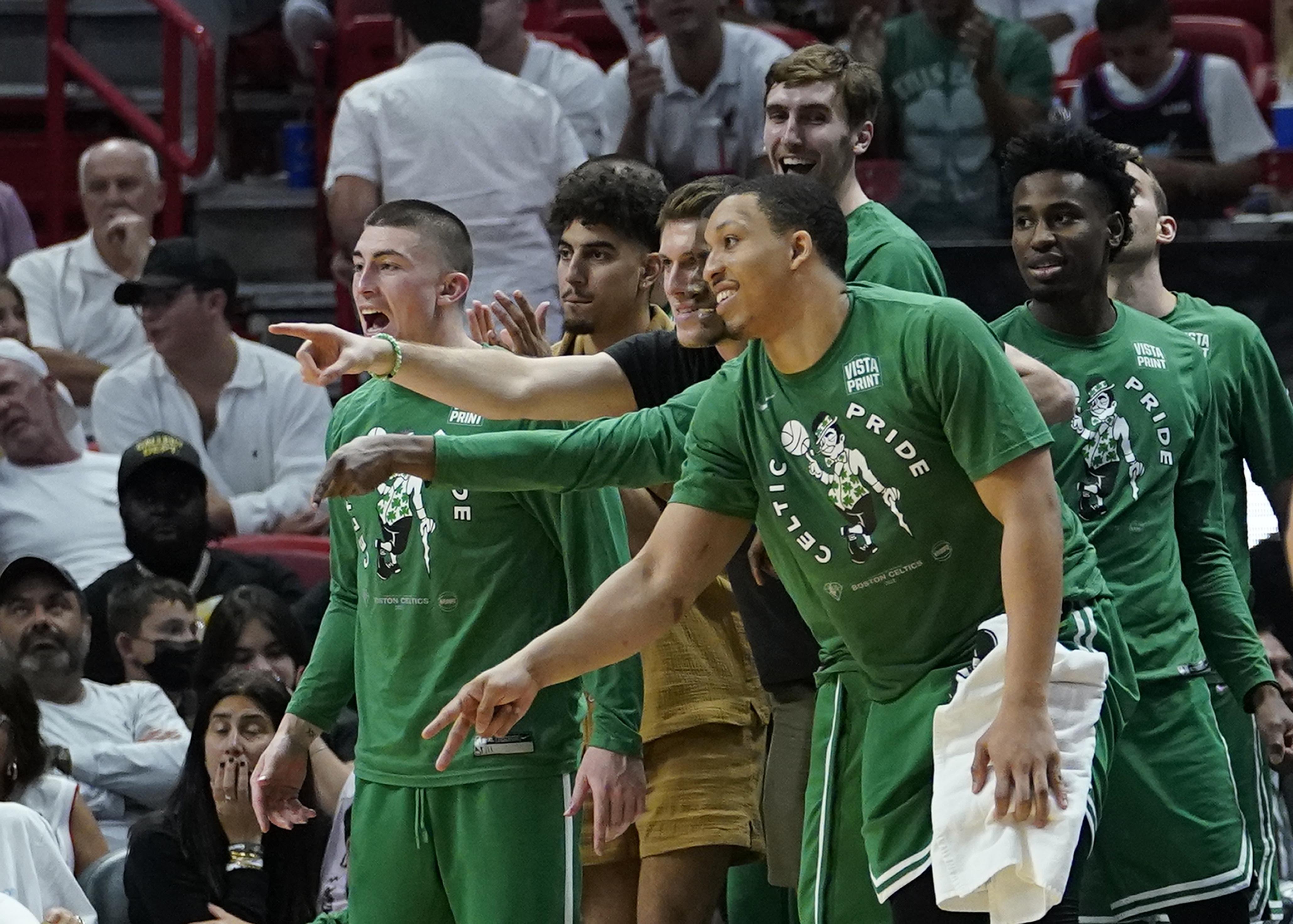 Boston Celtics players cheer the team from the bench during the second half of Game 2 of the NBA basketball Eastern Conference finals playoff series against the Miami Heat, Thursday, May 19, 2022, in Miami. 