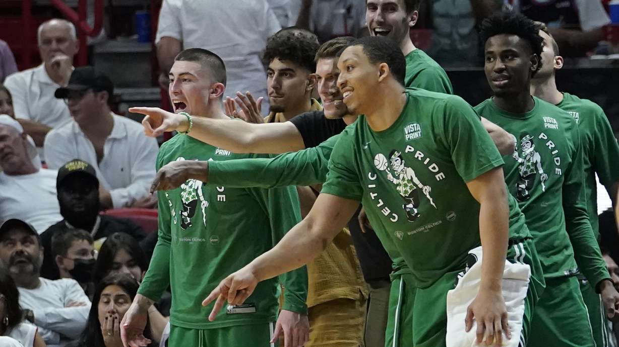 Boston Celtics players cheer the team from the bench during the second half of Game 2 of the NBA basketball Eastern Conference finals playoff series against the Miami Heat, Thursday, May 19, 2022, in Miami.