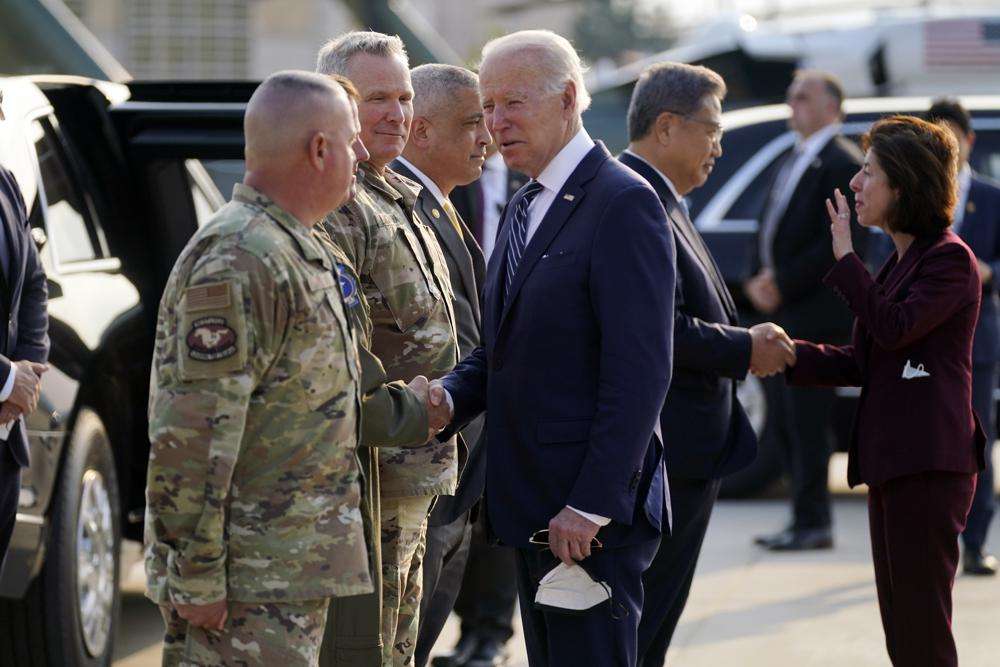 U.S. military personel greet President Joe Biden as he arrives at Osan Air Base, Friday, in Pyeongtaek, South Korea. Biden's approval rating dipped to the lowest point of his presidency in May, a new poll shows, with deepening pessimism emerging among members of his own Democratic Party.