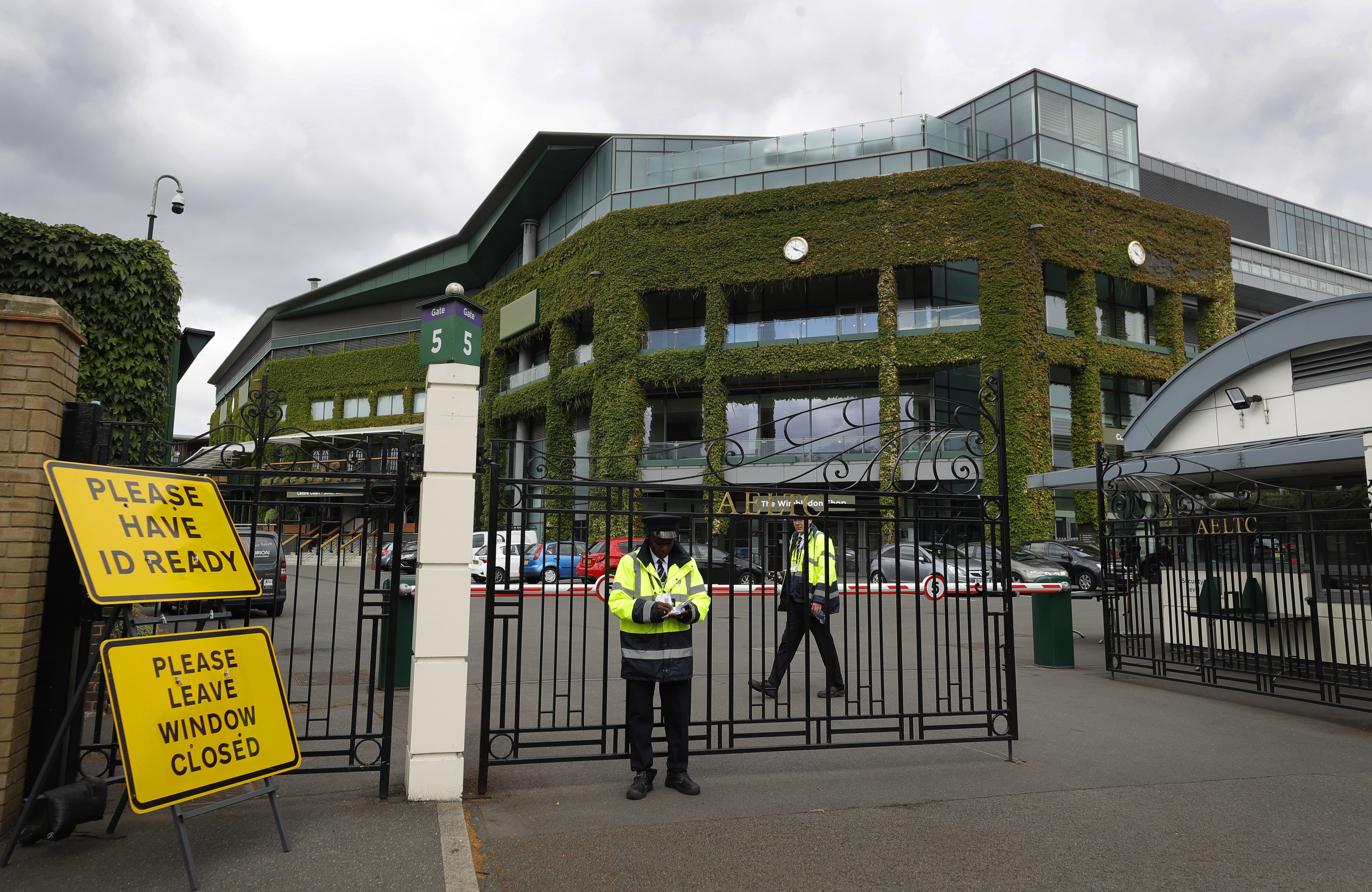 FILE - Security guards are shown at the gate in front of Centre Court at the All England Lawn Tennis Club, after the 2020 tennis championships were canceled due to the coronavirus, in Wimbledon, London, Monday, June 29, 2020. The ATP men’s professional tennis tour will not award ranking points for Wimbledon this year because of the All England Club’s ban on players from Russia and Belarus over the invasion of Ukraine. The ATP announced its decision Friday night, May 20, 2022, two days before the start of the French Open — and a little more than a month before play begins at Wimbledon on June 27. It is a highly unusual and significant rebuke of the oldest Grand Slam tournament.