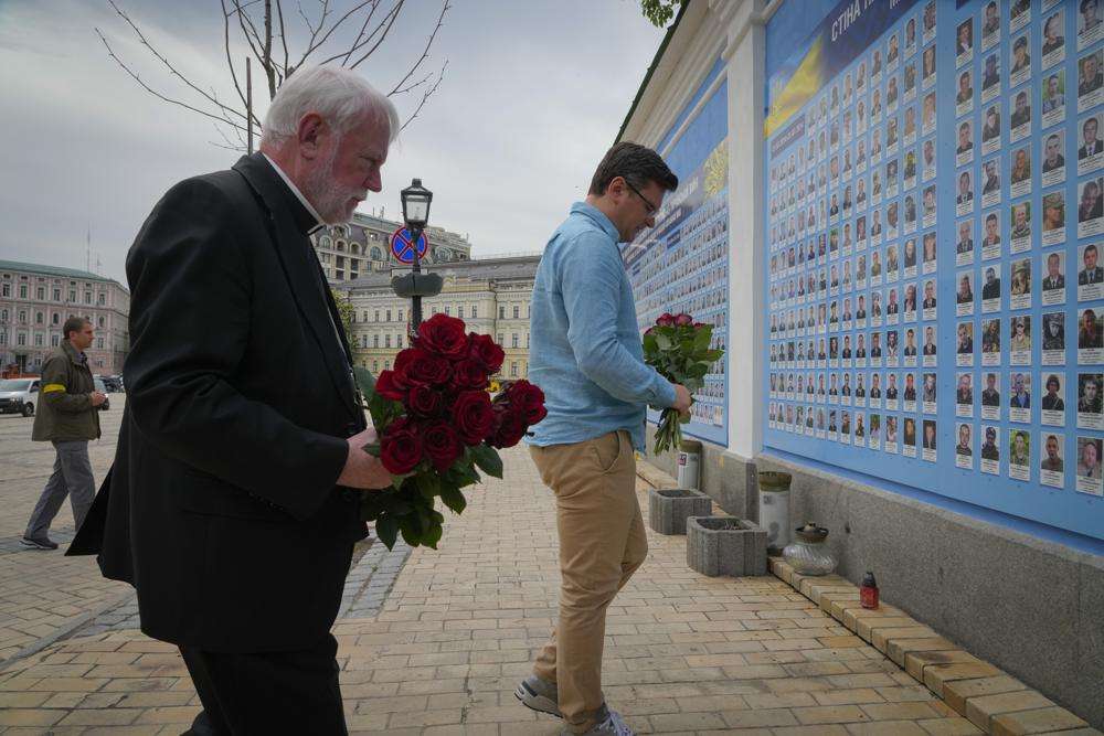 Ukrainian Foreign Minister Dmytro Kuleba, right, and Vatican Secretary for Relations with States Archbishop Paul Richard Gallagher lay flowers at the Memorial Wall of Fallen Defenders of Ukraine in Russian-Ukrainian War in Kyiv, Ukraine, Friday. Russia claims to have captured Mariupol in what would be its biggest victory yet in its war with Ukraine.