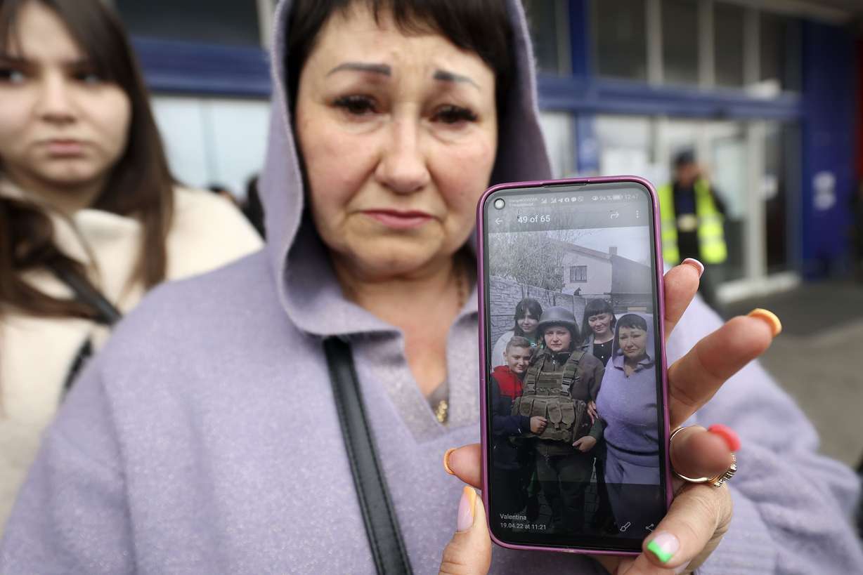 Ukrainian refugee Valentina Chernyshova shows a photo of when she said goodbye to her daughter, who is fighting in the war against Russia, outside of an old Tesco store that is being used to house refugees in Przemysl, Poland, on April 21.