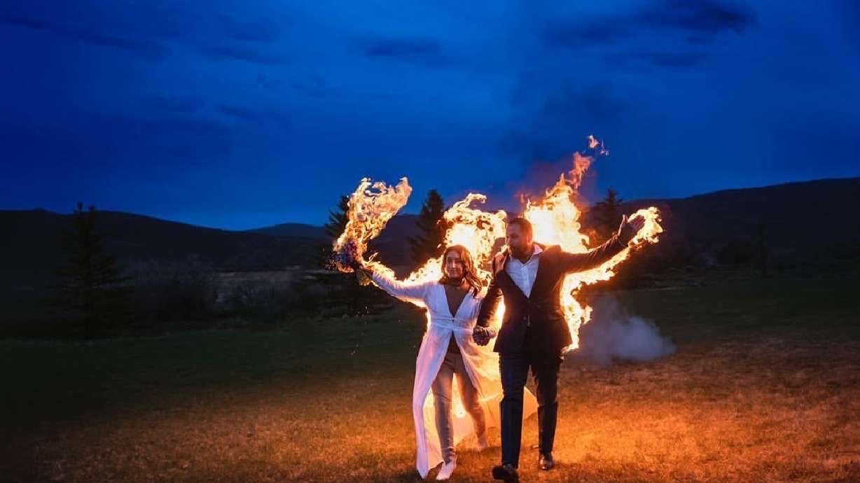 Gabe Jessop and Ambyr Mishelle walk the shores of Jordanelle State Park in flames at their wedding earlier this month.