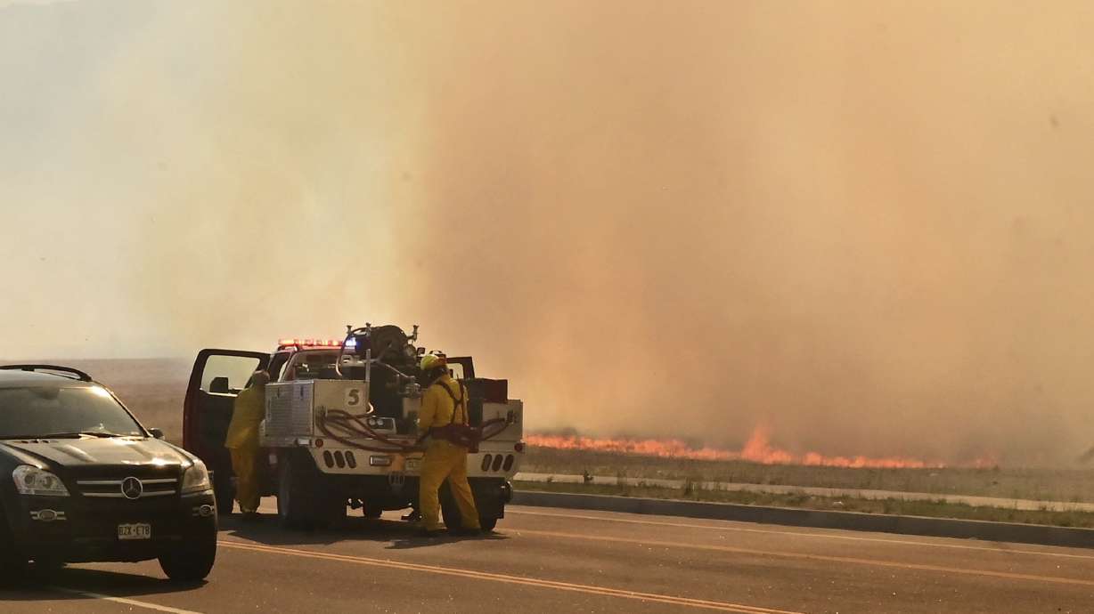 A firefighting crew arrives at the scene of a field fire adjacent to the Amazon Distribution Center in Colorado Springs, Colo., on May 12. More than 5,000 firefighters are battling multiple wildland blazes in dry, windy weather across the Southwest. Evacuation orders remained in place Thursday for residents near fires in Texas, Colorado and New Mexico.