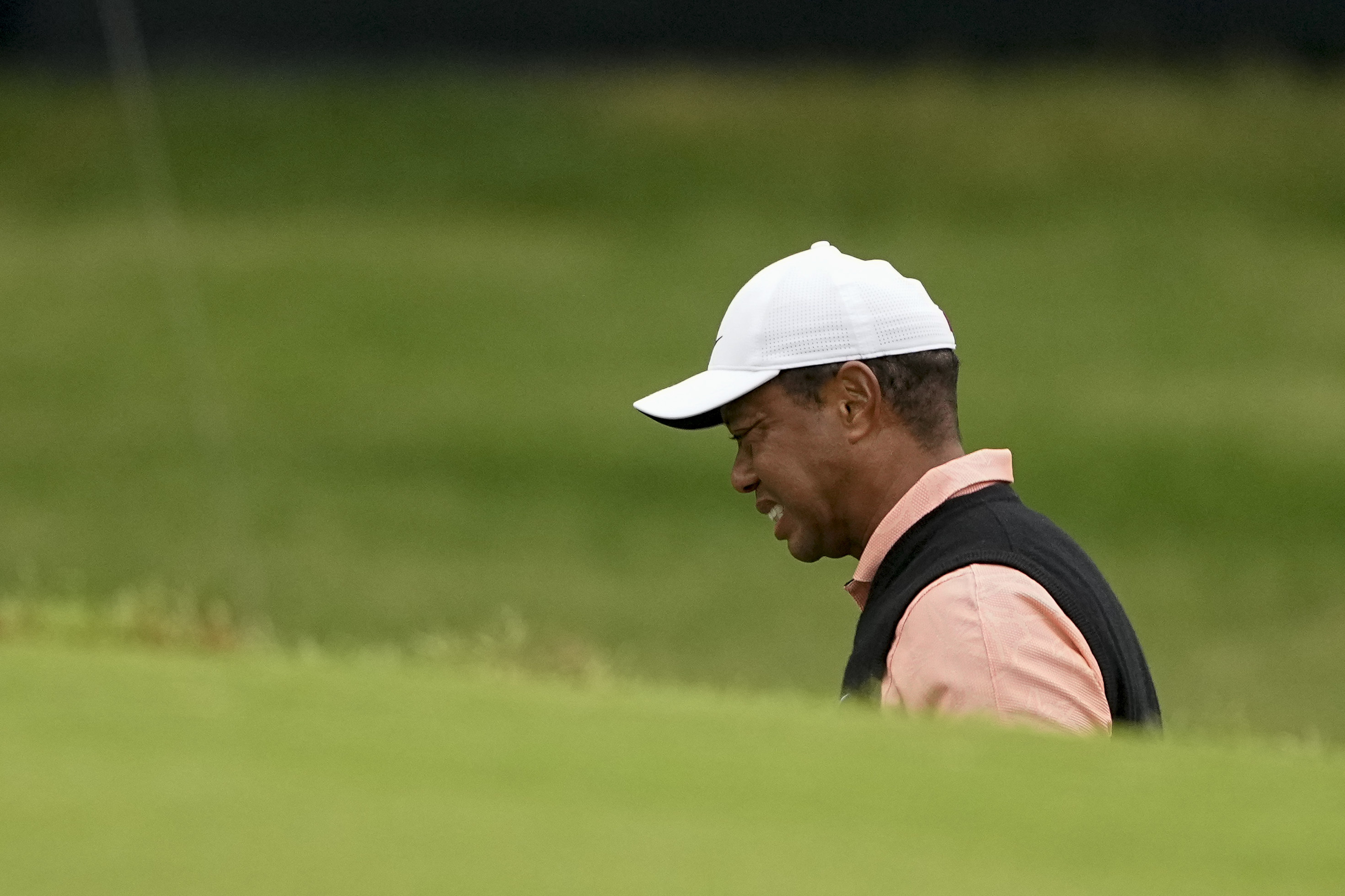 Tiger Woods grimaces on the 18th hole during the third round of the PGA Championship golf tournament at Southern Hills Country Club, Saturday, May 21, 2022, in Tulsa, Okla. 