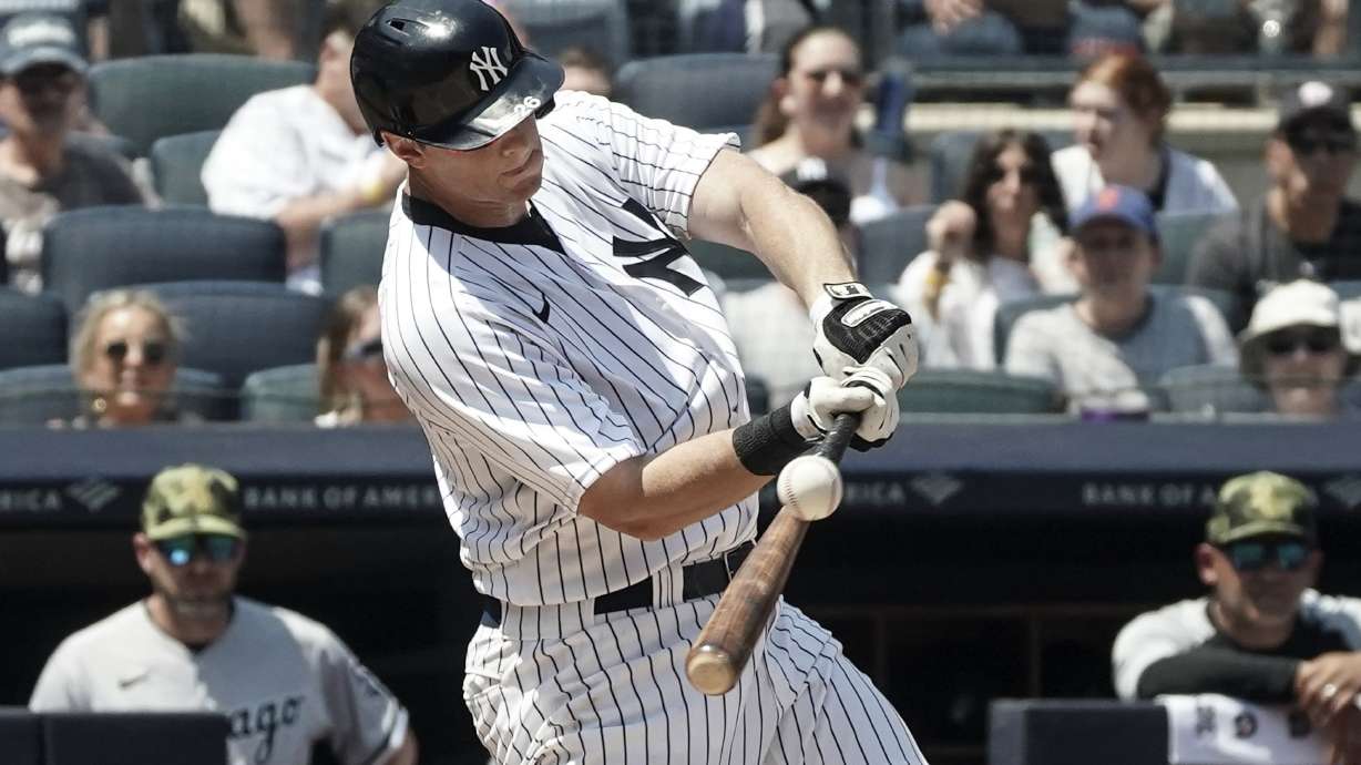 New York Yankees' DJ LeMahieu (26) hits a grand slam during the second inning of a baseball game against Chicago White Sox, Saturday, May 21, 2022, in New York.