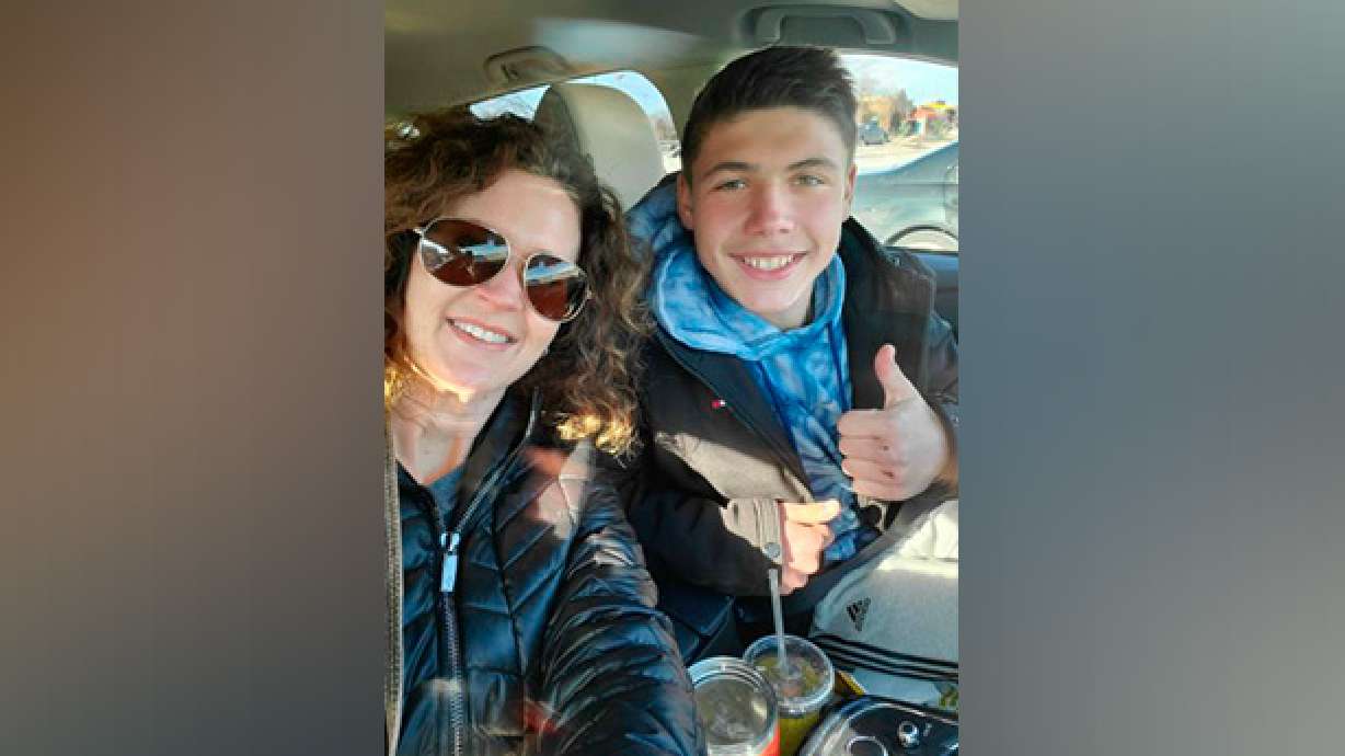 Jessica Pflumm of Olathe, Kansas, poses with Maks, a Ukrainian boy she and her family are working to adopt. The Pflumms are among dozens of families whose adoptions are on hold because of the war in Ukraine. Russia’s invasion of Ukraine has halted the process of international adoption. Ukraine has stopped all international adoptions as the country copes with the turmoil unleashed on its courts by the war.