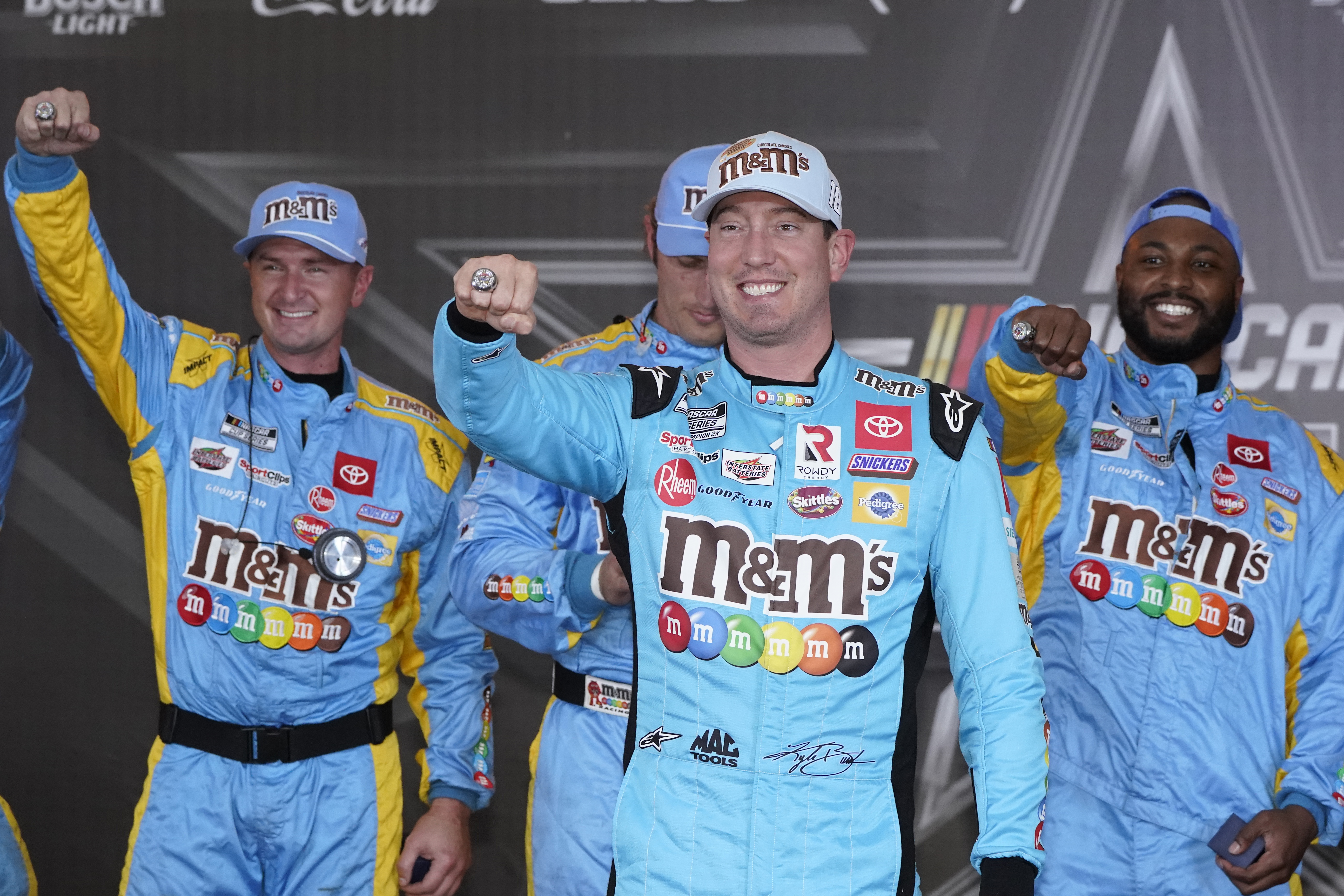 Kyle Busch, front, and his crew show off their pole position rings after qualifications for the NASCAR All-Star auto race at Texas Motor Speedway in Fort Worth, Texas, Saturday, May 21, 2022.