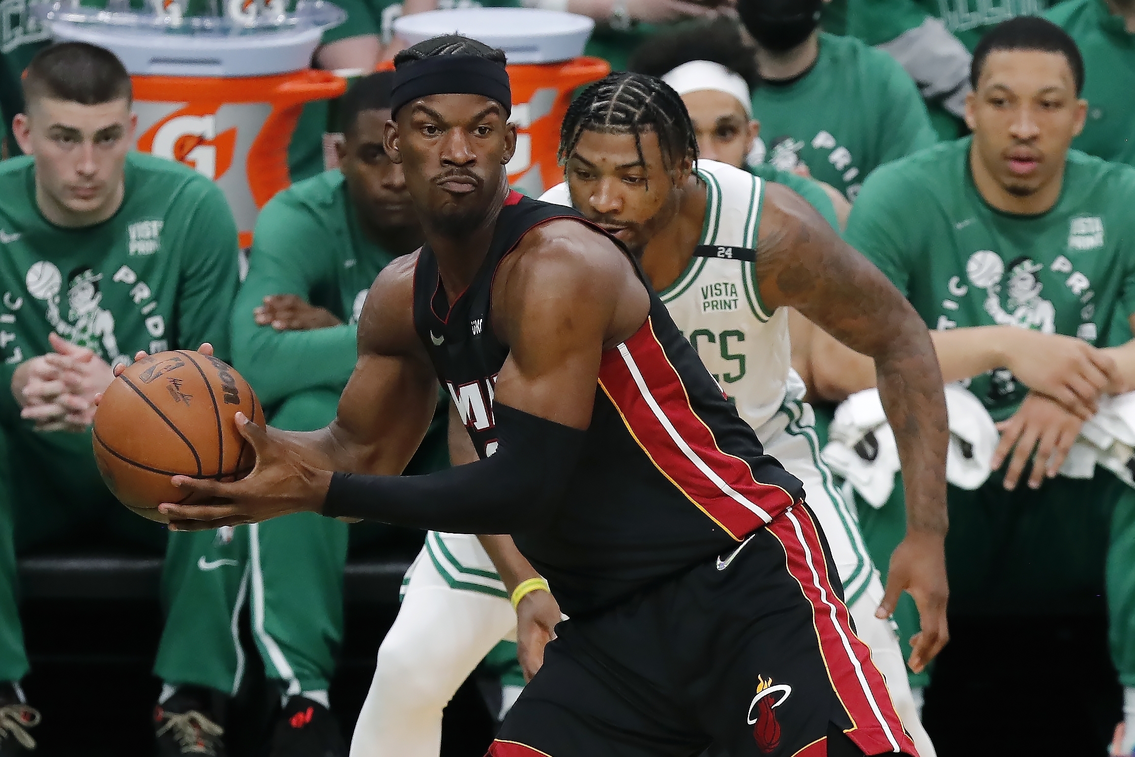 Miami Heat's Jimmy Butler (22) intercepts a pass intended for Boston Celtics' Marcus Smart, behind, during the first half of Game 3 of the NBA basketball playoffs Eastern Conference finals Saturday, May 21, 2022, in Boston. 