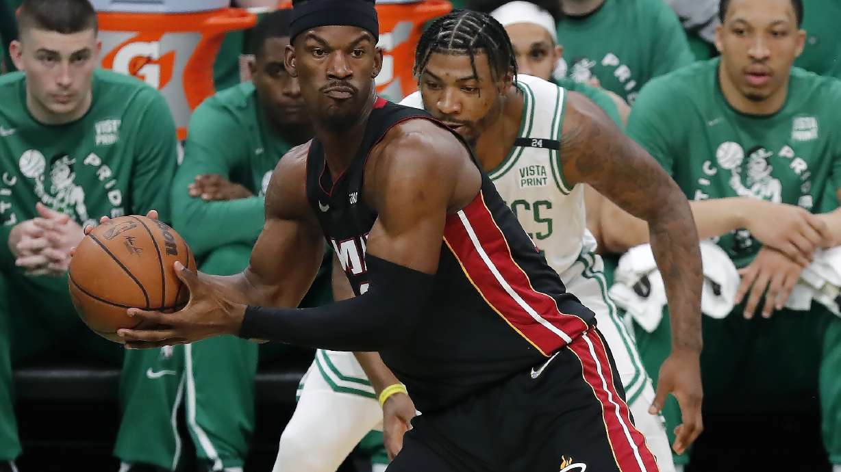 Miami Heat's Jimmy Butler (22) intercepts a pass intended for Boston Celtics' Marcus Smart, behind, during the first half of Game 3 of the NBA basketball playoffs Eastern Conference finals Saturday, May 21, 2022, in Boston.