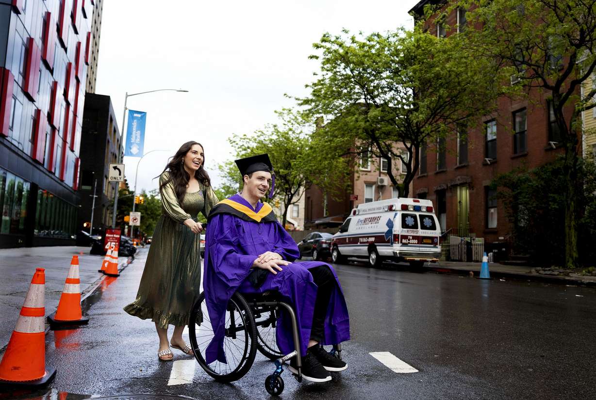 Ellis Brown and her husband, Spencer, leave the Barclays Center in Brooklyn, N.Y., on Monday, May 16, after Spencer’s commencement ceremony from New York University’s Tandon School of Engineering.