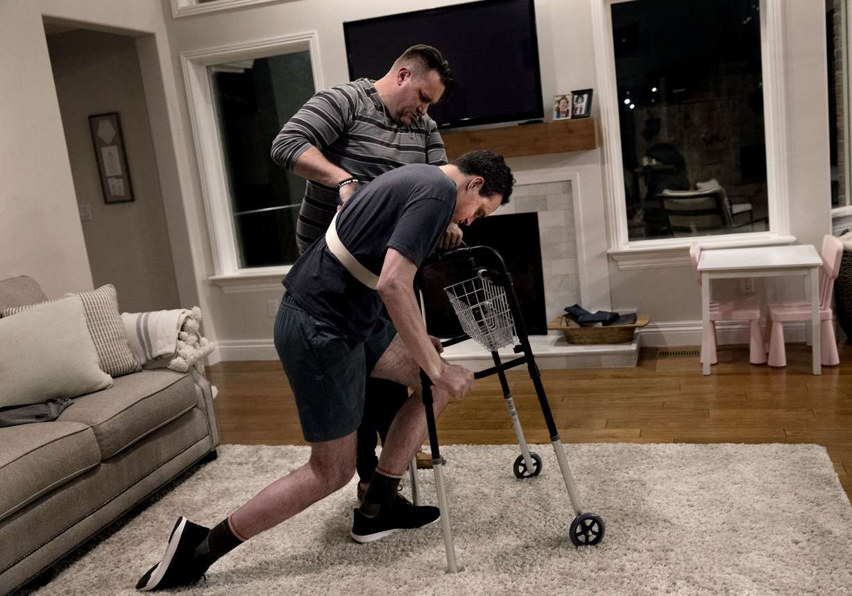 Clint Curtis helps Spencer Brown with his rehab at his home in Alpine on Tuesday, April 19.