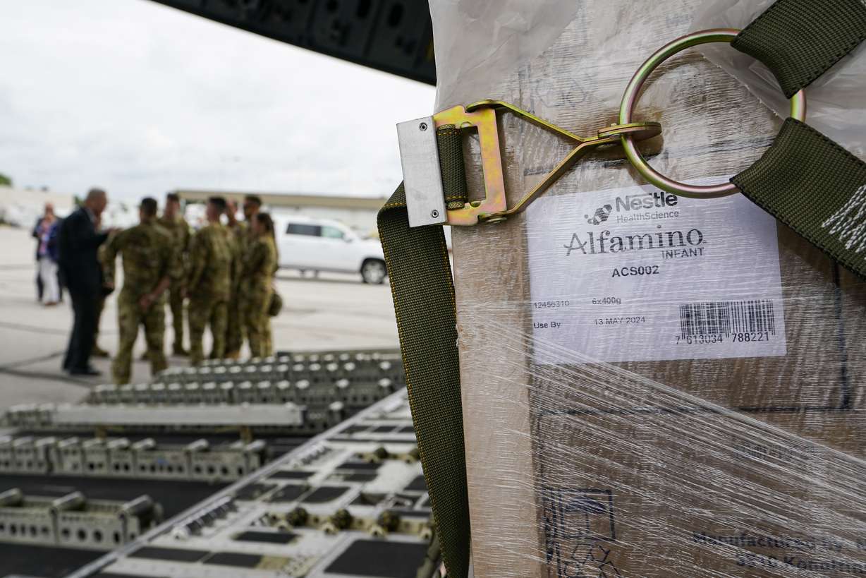 Agriculture Secretary Tom Vilsack, left, greets crew members of a C-17 that delivered a plane load of baby formula at the Indianapolis International Airport in Indianapolis, Sunday. The 132 pallets of Nestlé Health Science Alfamino Infant and Alfamino Junior formula arrived from Ramstein Air Base in Germany