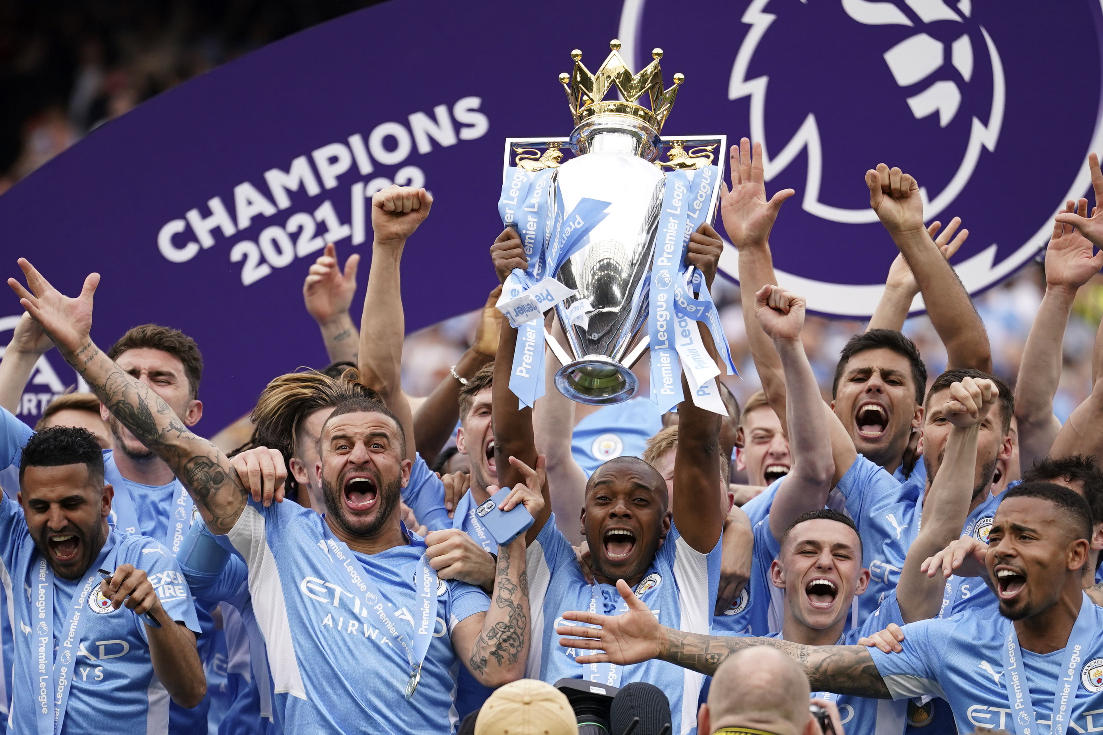 Manchester City players celebrate with trophy after winning the 2022 English Premier League title at the Etihad Stadium in Manchester, England, Sunday, May 22, 2022. 