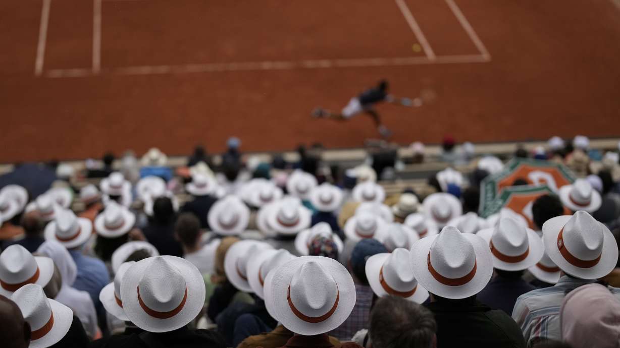 Spectators watch first round matches at the French Open tennis tournament in Roland Garros stadium in Paris, France, Sunday, May 22, 2022.
