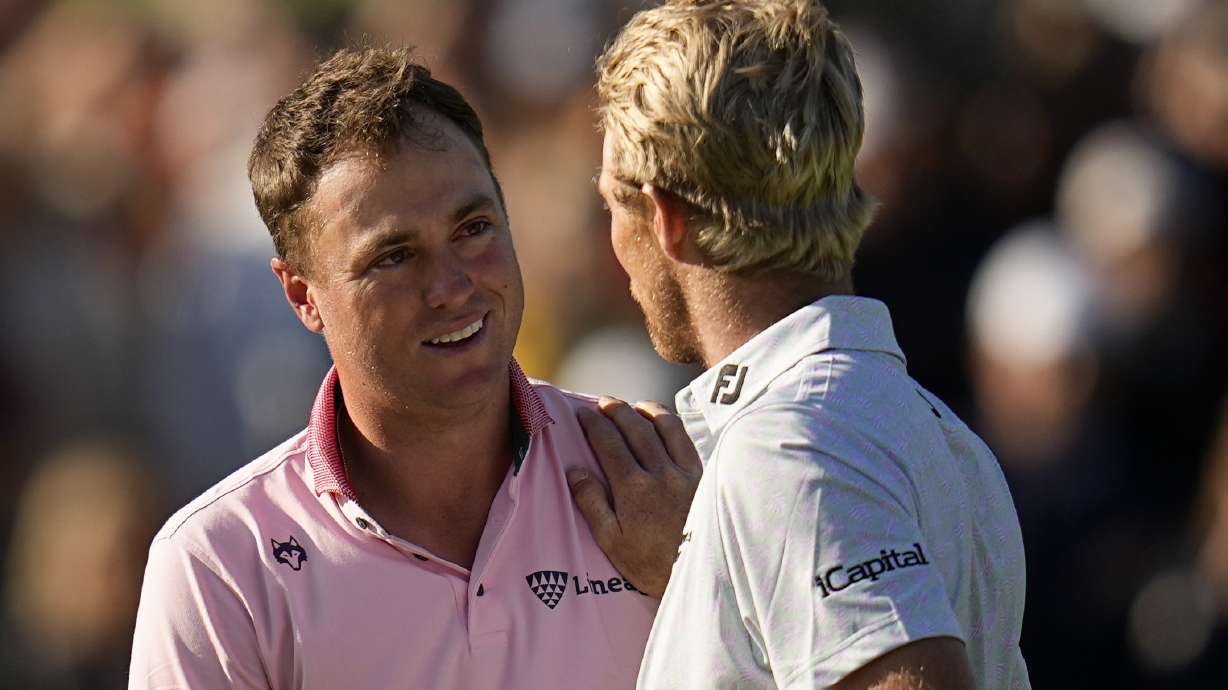 Justin Thomas, left, is greeted by Will Zalatoris after winning the PGA Championship golf tournament in a playoff at Southern Hills Country Club, Sunday, May 22, 2022, in Tulsa, Okla.