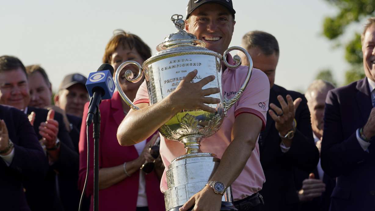 Justin Thomas holds the Wanamaker Trophy after winning the PGA Championship golf tournament in s playoff against Will Zalatoris at Southern Hills Country Club, Sunday, May 22, 2022, in Tulsa, Okla.