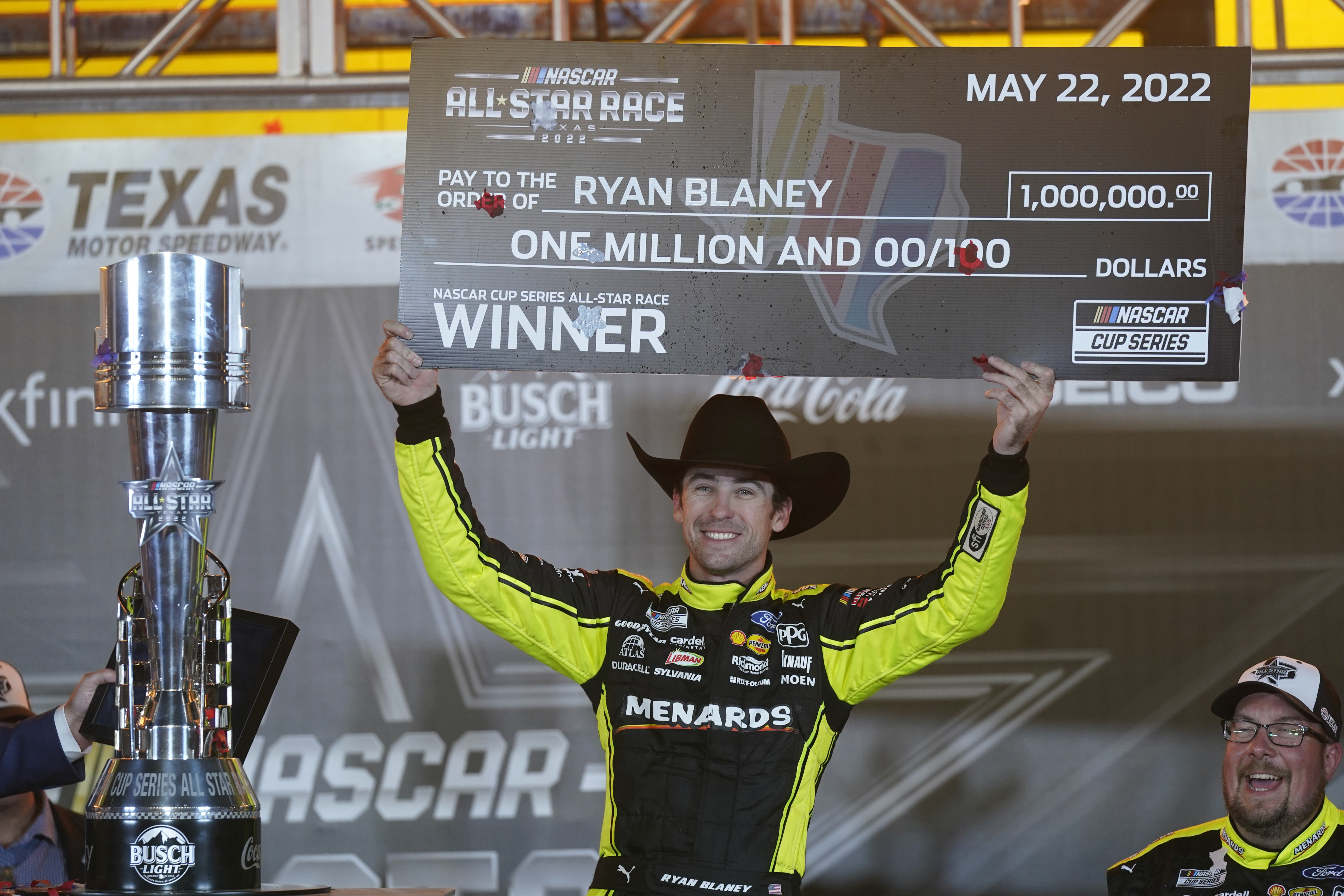 Ryan Blaney (12) hold up the first place check while celebrating in Victory Lane after winning the NASCAR All-Star auto race at Texas Motor Speedway in Fort Worth, Texas, Sunday, May 22, 2022. 