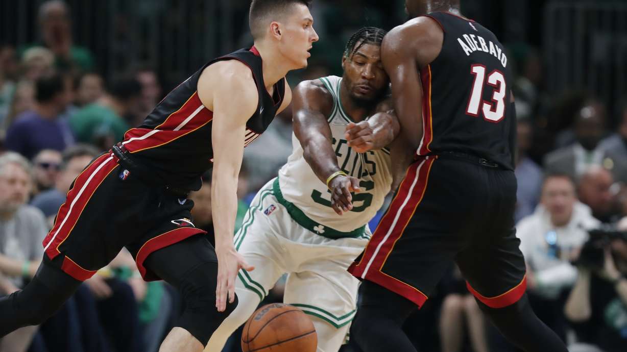 Miami Heat's Bam Adebayo (13) screens Boston Celtics' Marcus Smart (36) as Tyler Herro, left, drives during the second half of Game 3 of the NBA basketball Eastern Conference finals playoff series, Saturday, May 21, 2022, in Boston.