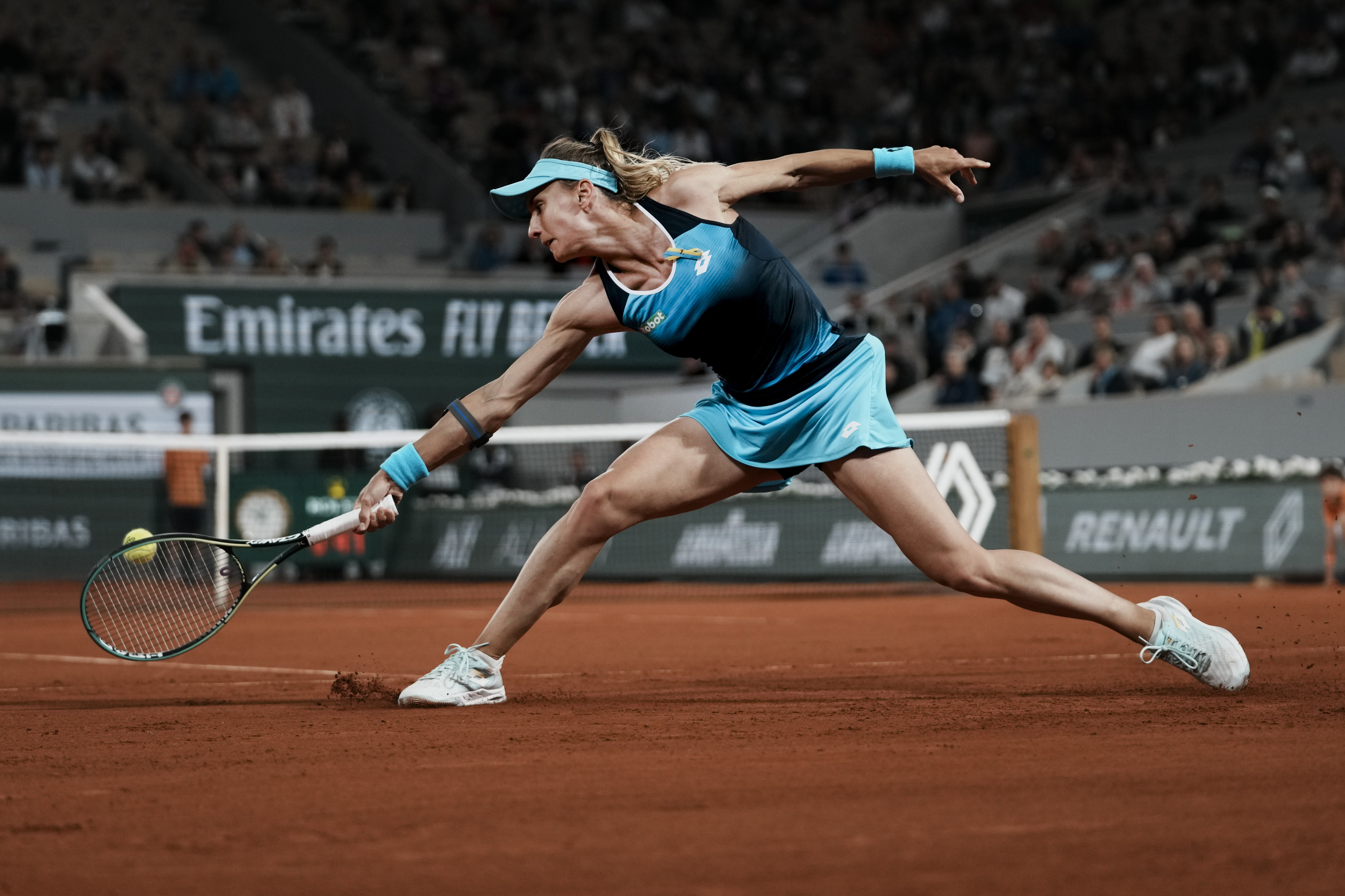 Ukraine's Lesia Tsurenko plays a shot against Poland's Iga Swiatek during their first round match at the French Open tennis tournament in Roland Garros stadium in Paris, France, Monday, May 23, 2022. 