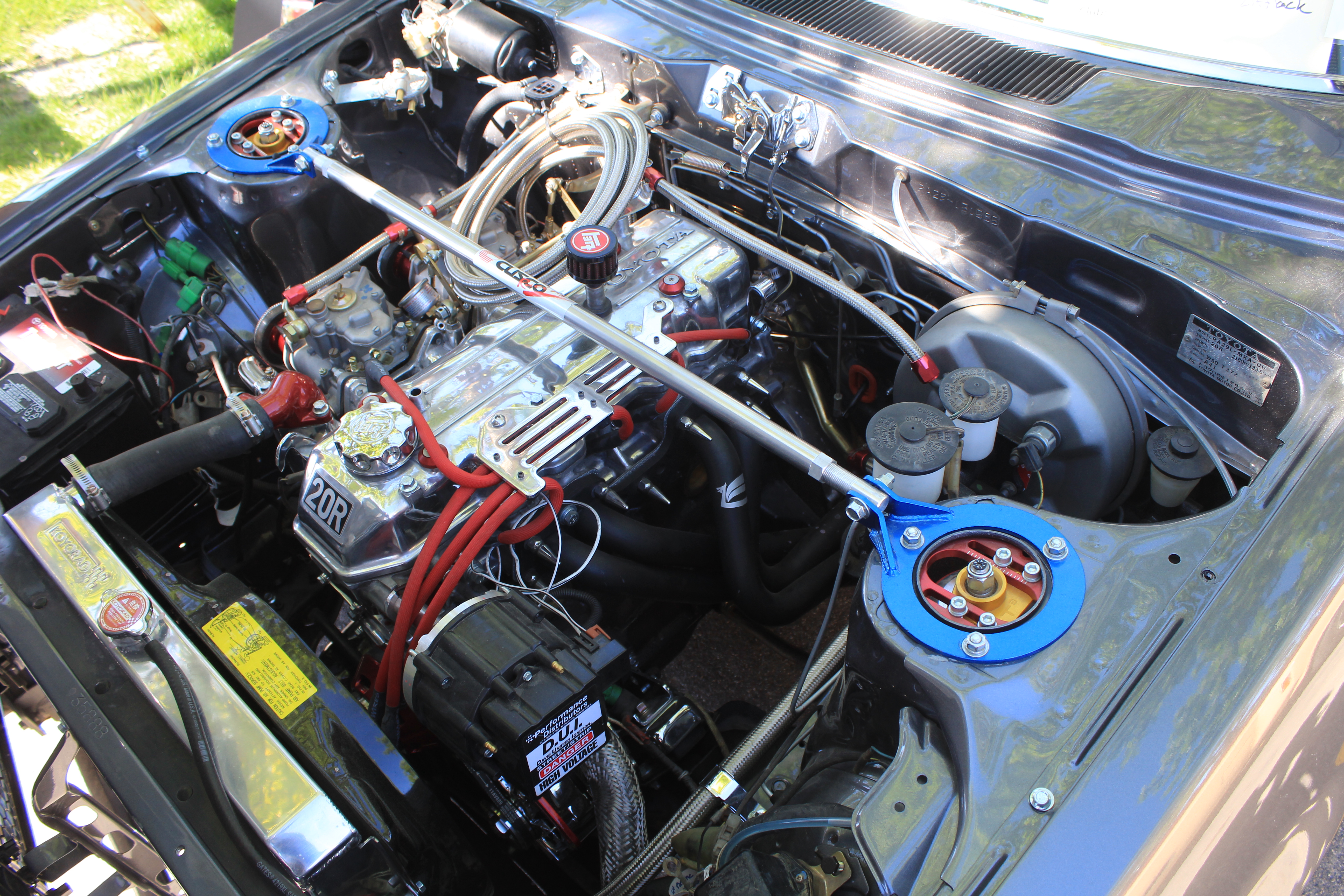 The engine bay of Josh Wheeler's 1977 Toyota Celica starts with the original 20-R engine but adds upgrades, he says. The engine is shown here at the Utah Valley University Auto Expo on May 21.