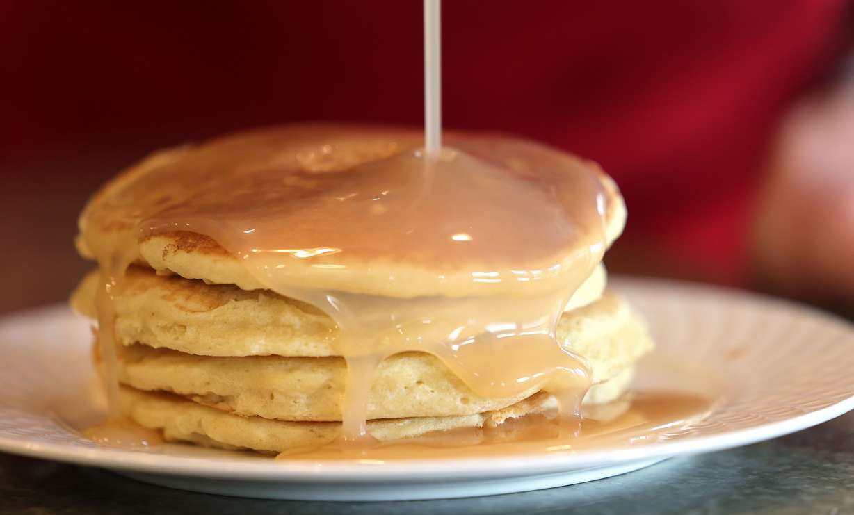 Jared Smith pours syrup over a stack of pancakes in Cottonwood Heights on May 9.