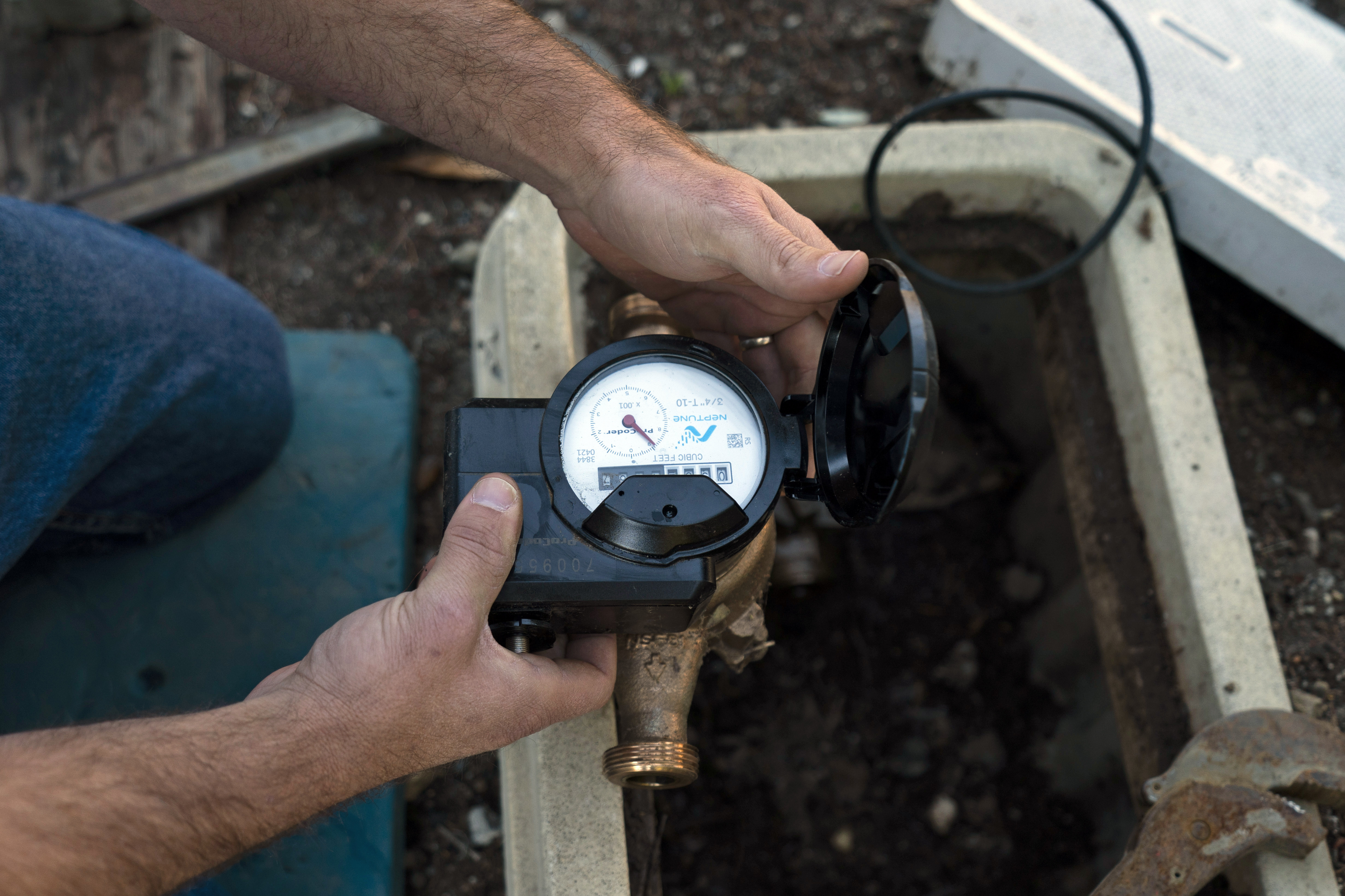 Cason Gilmer, a senior field customer service representative from the Las Virgenes Municipal Water District, installs an advanced water metering system in Agoura Hills, Calif., Jan. 5. Many Western cities over the past three decades have diversified their water sources, boosted local supplies, and use water more efficiently now than in the past.