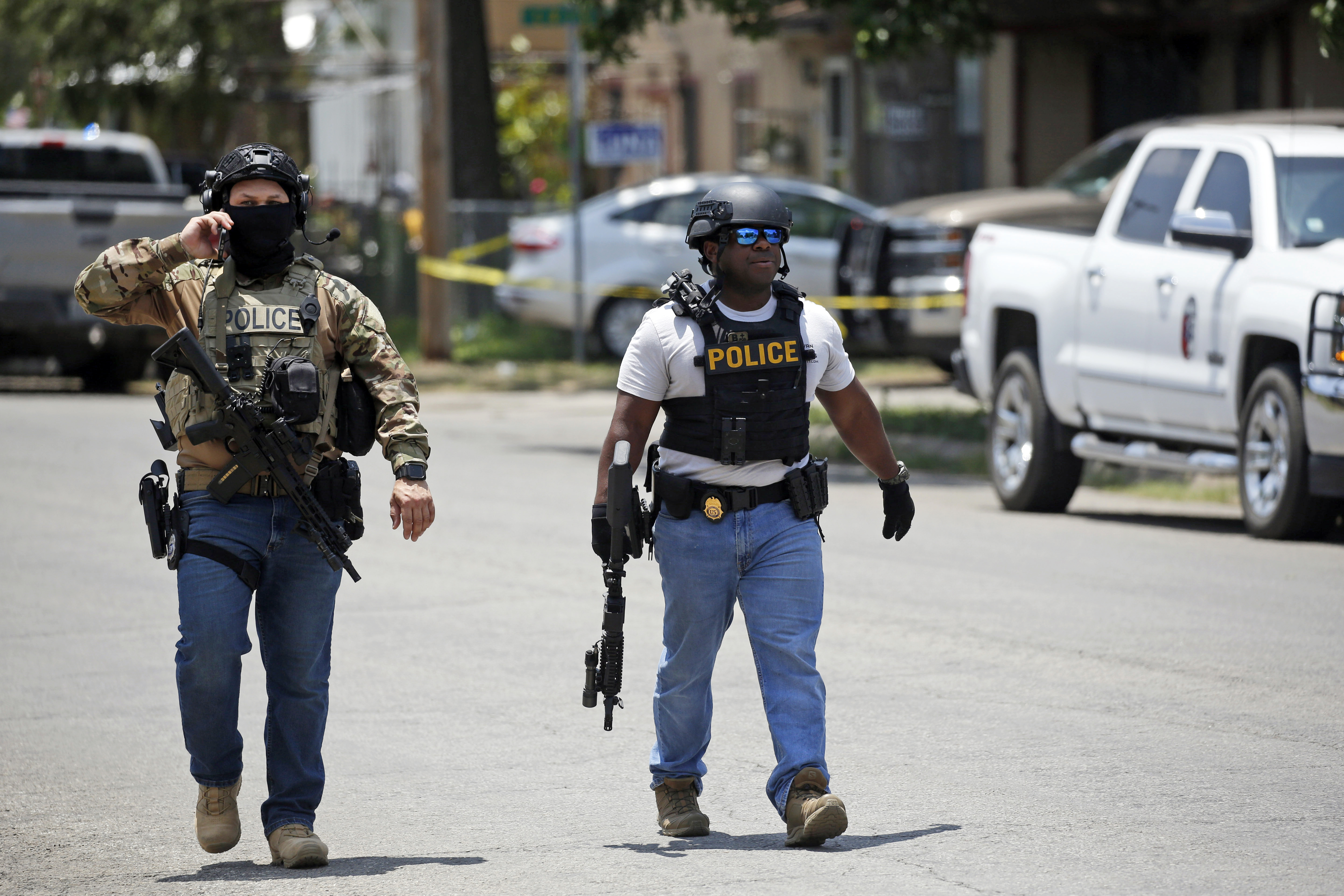 Police walk near Robb Elementary School following a shooting on Tuesday in Uvalde, Texas. One day after the tragic shooting that left 19 children and two adults dead, a Utah state senator wants to raise the minimum age to purchase a firearm to 21.