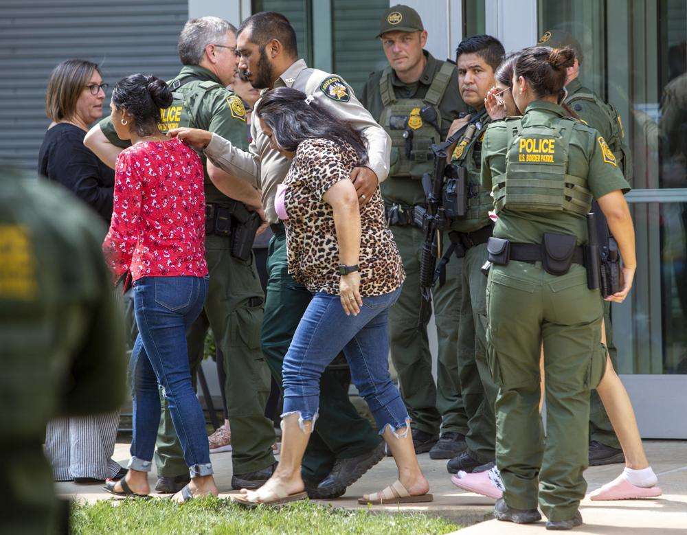 People leave the Uvalde Civic Center following a shooting earlier in the day at Robb Elementary School, Tuesday, in Uvalde, Texas.