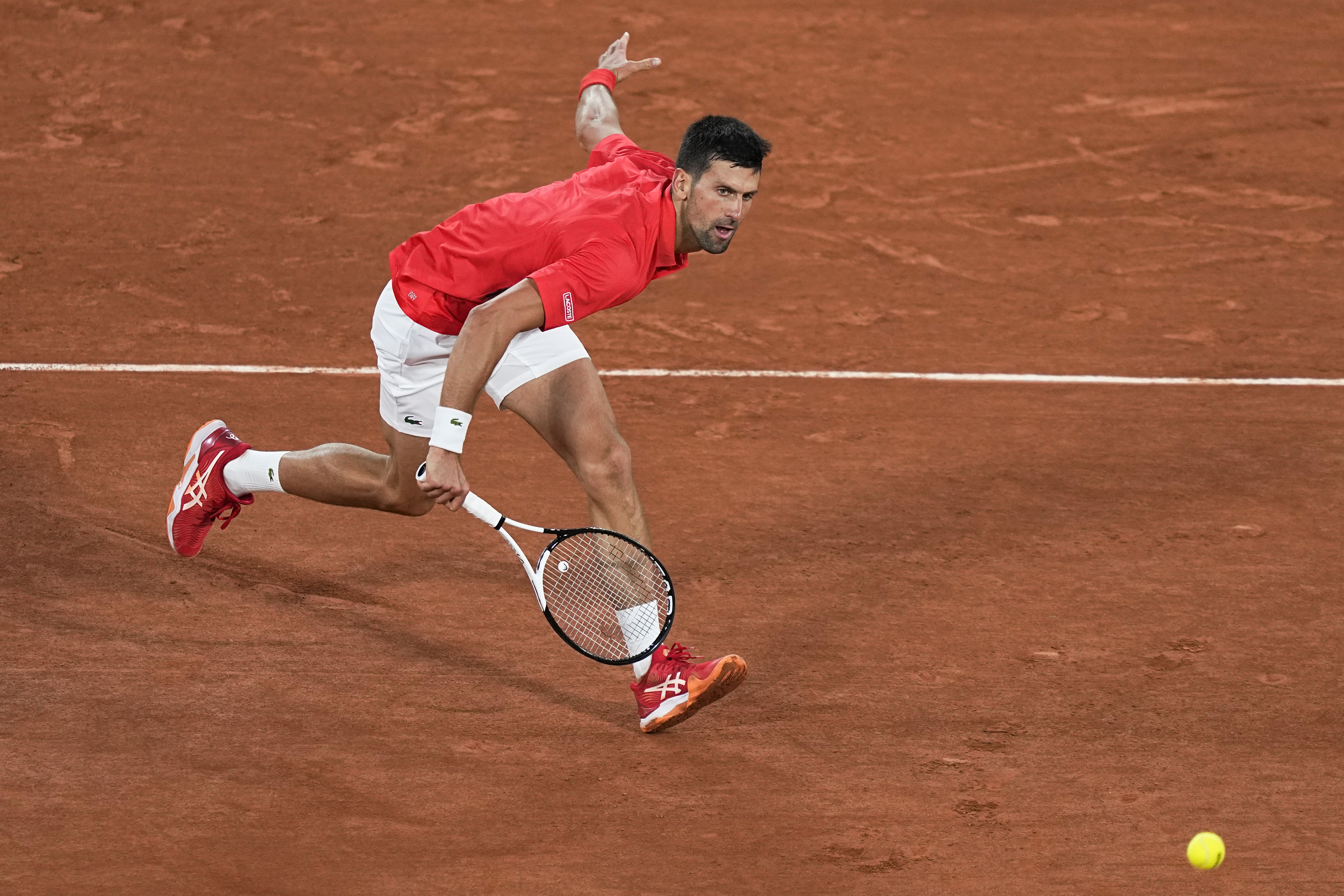 Serbia's Novak Djokovic plays a shot against Japan's Yoshihito Nishioka during their first round match at the French Open tennis tournament in Roland Garros stadium in Paris, France, Monday, May 23, 2022. 