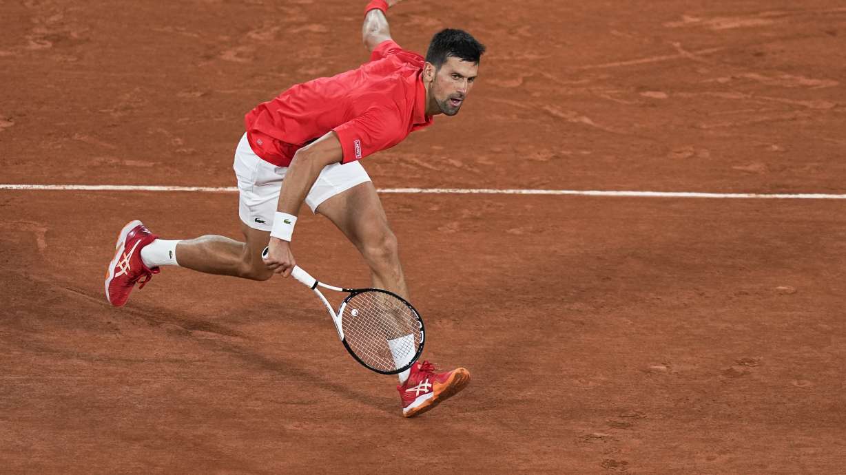 Serbia's Novak Djokovic plays a shot against Japan's Yoshihito Nishioka during their first round match at the French Open tennis tournament in Roland Garros stadium in Paris, France, Monday, May 23, 2022.
