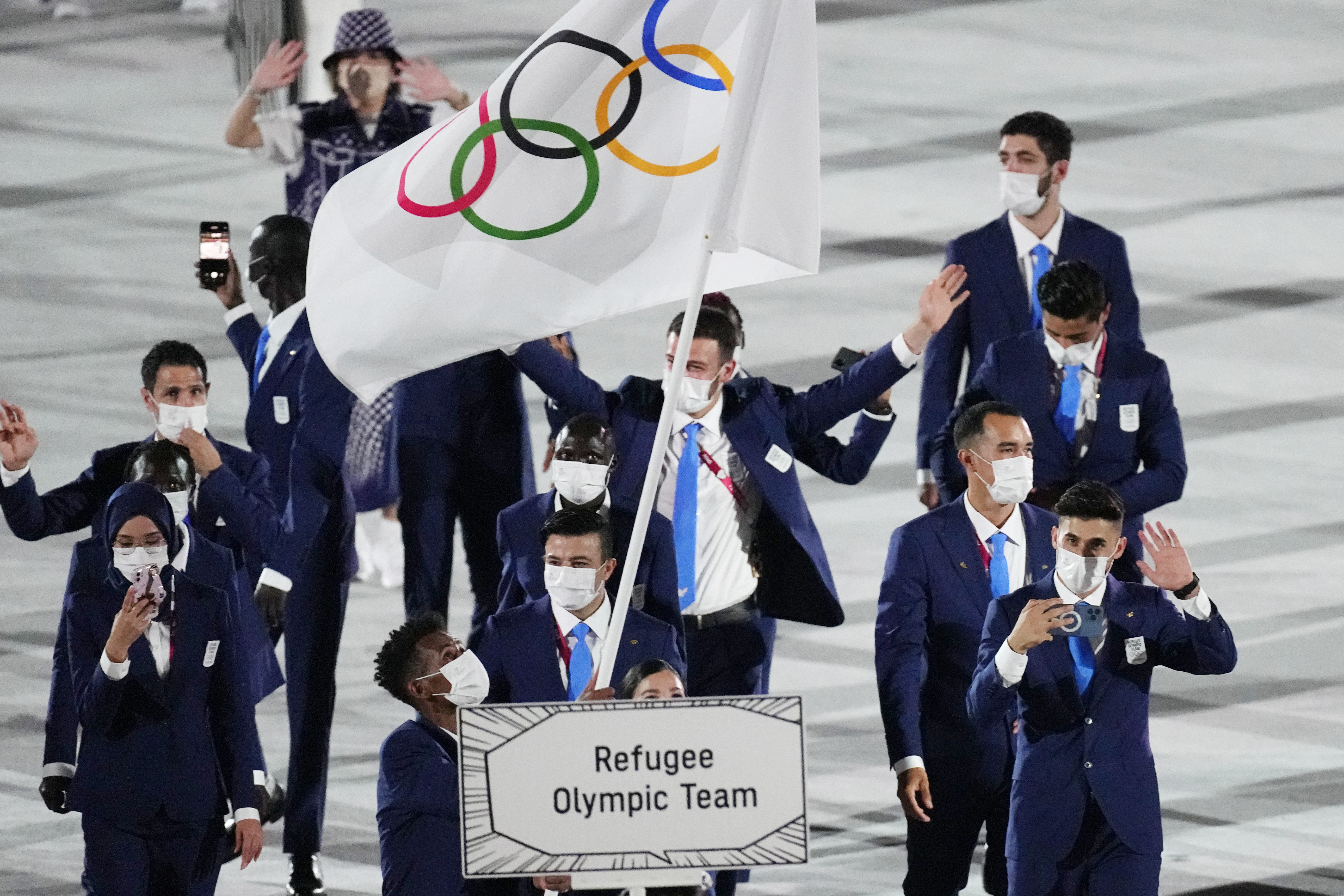 FILE - Yusra Mardini and Tachlowini Gabriyesos, of the Refugee Olympic Team, carry the Olympic flag during the opening ceremony in the Olympic Stadium at the 2020 Summer Olympics in Tokyo, Japan, Friday, July 23, 2021. The Olympic Refugee Foundation and the refugee Olympics team are the winners of this year’s Princess of Asturias Award for sports, the Spanish foundation that organizes the prizes said Wednesday, May 25, 2022. 