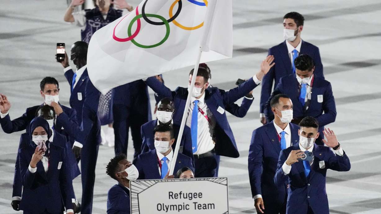 FILE - Yusra Mardini and Tachlowini Gabriyesos, of the Refugee Olympic Team, carry the Olympic flag during the opening ceremony in the Olympic Stadium at the 2020 Summer Olympics in Tokyo, Japan, Friday, July 23, 2021. The Olympic Refugee Foundation and the refugee Olympics team are the winners of this year’s Princess of Asturias Award for sports, the Spanish foundation that organizes the prizes said Wednesday, May 25, 2022.